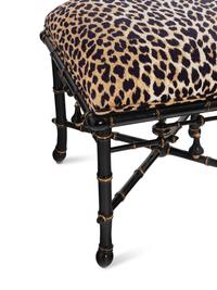 A Pair of Baker Upholstered and Ebonized Faux-Bamboo Footstools