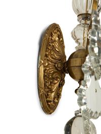 A Pair of Louis XV Style Gilt Bronze and Cut Glass Three-Light Sconces