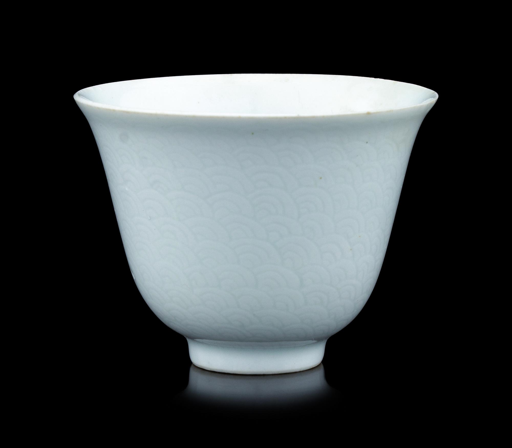 A Chinese Incised White Glazed Porcelain 'Waves' Cup
