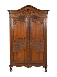 A French Provincial Carved Oak Armoire