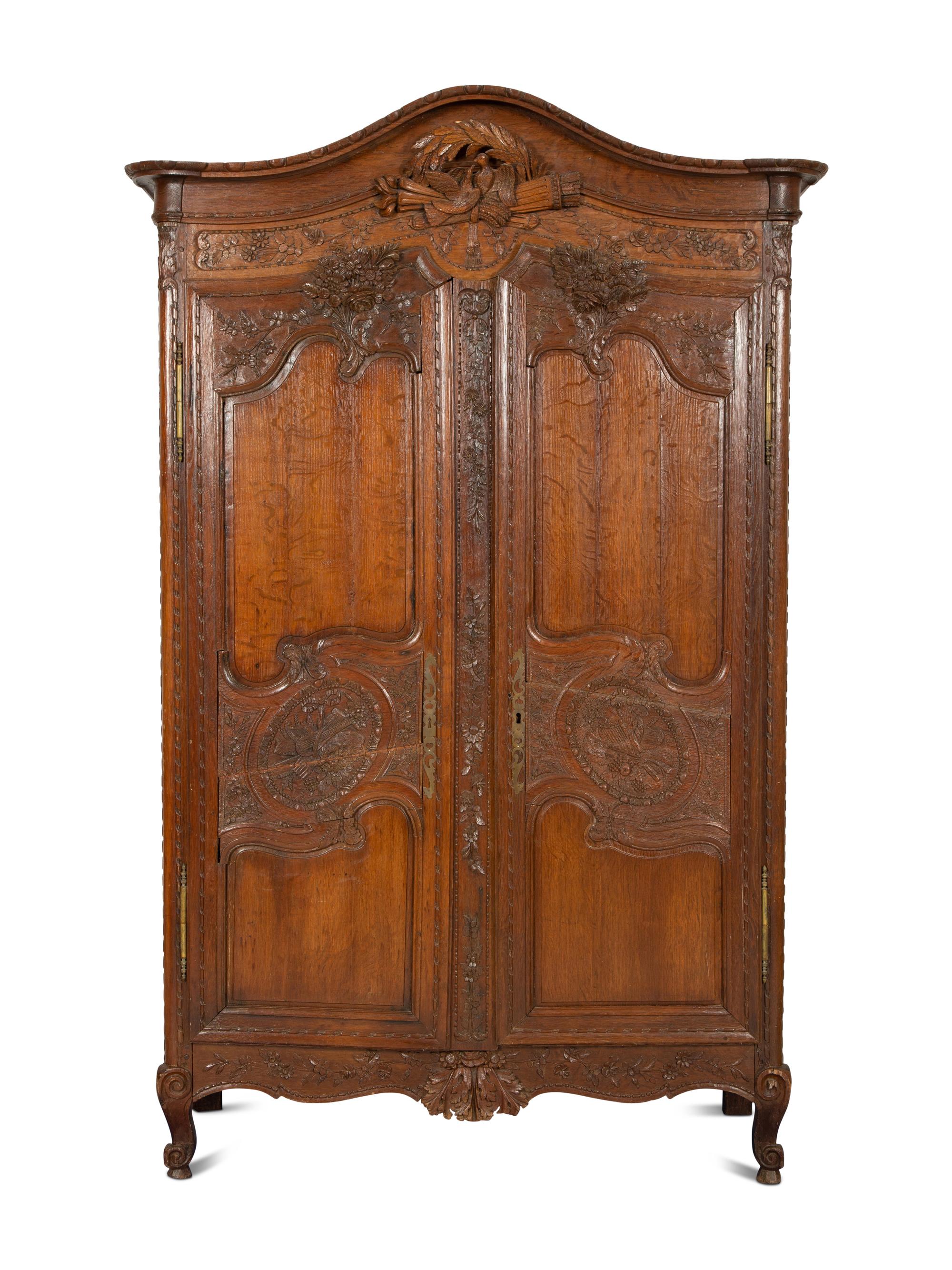 A French Provincial Carved Oak Armoire
