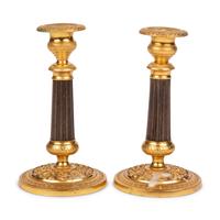 A Pair of Gilt Metal Mounted Candlesticks