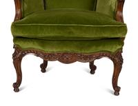A Louis XV Style Carved Fruitwood Bergère à Oreilles