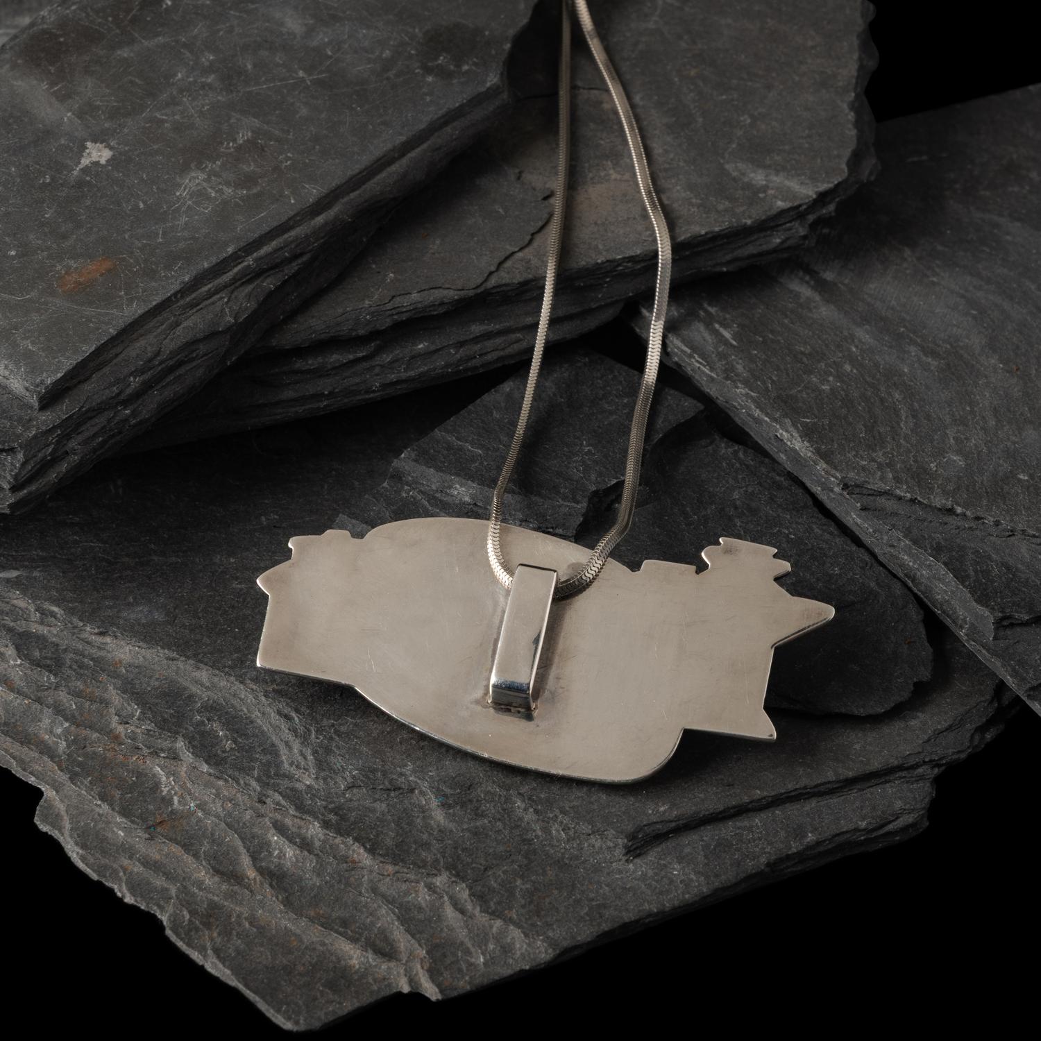 Gail Bird and Yazzie Johnson (Kewa-Laguna, b. 1949) / (Diné, b. 1946) — Figural Pendant with Multi-stone Inlay