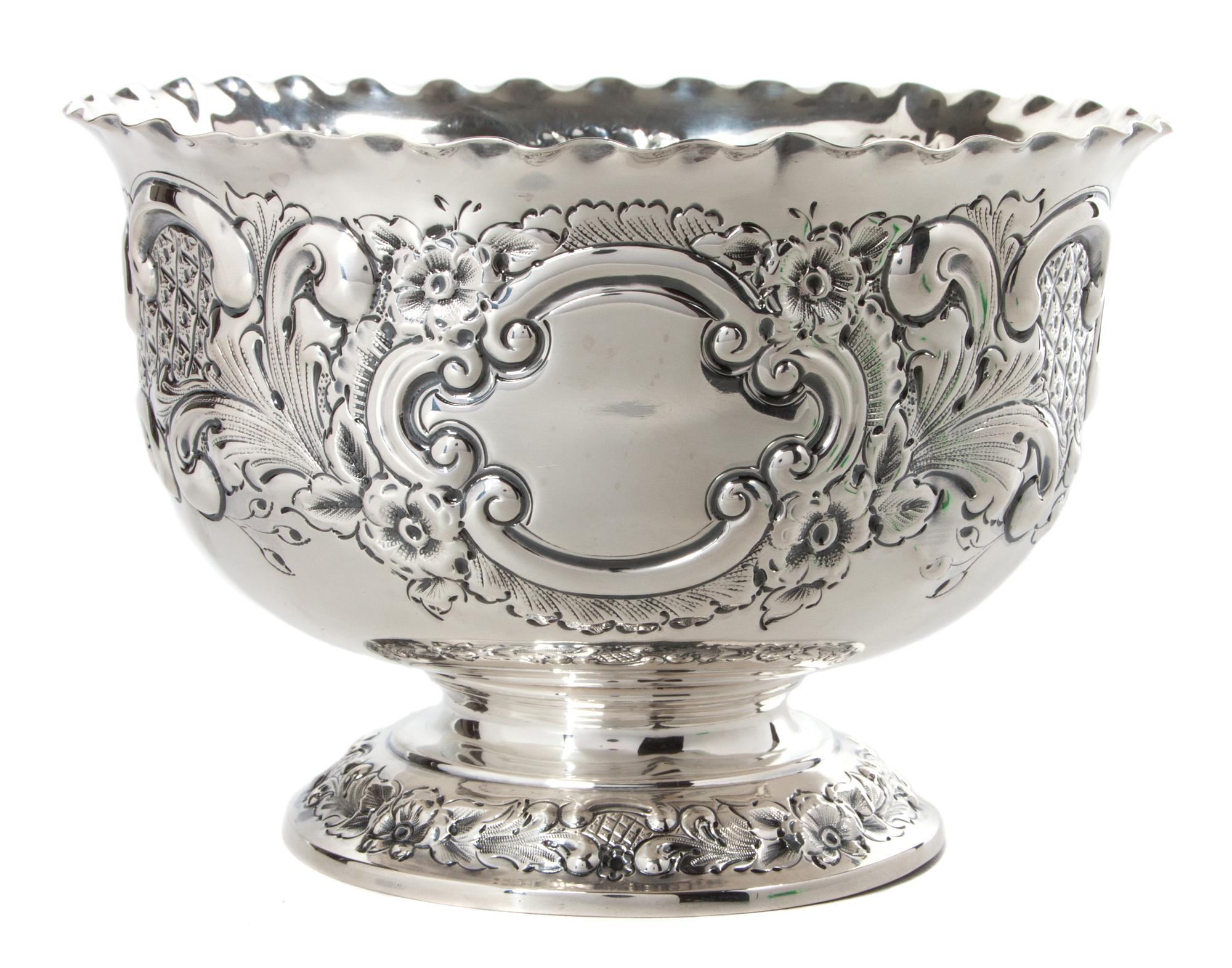 An English Silver Circular Footed Bowl, Goldsmiths and Sliversmiths, Co., London, 1920, the sides worked to show floral decoration.