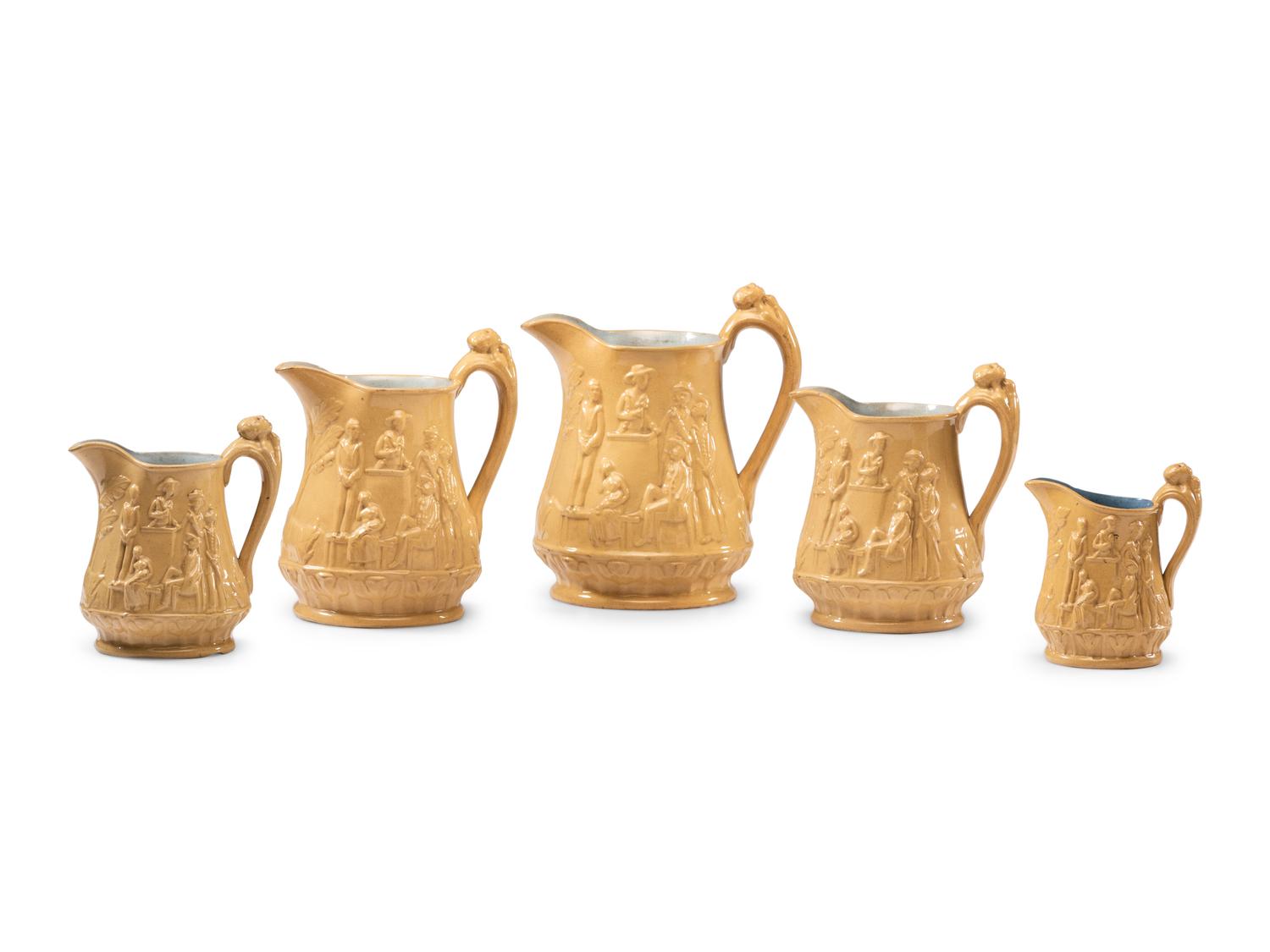 Five Graduated Abolitionist Yellowware Pitchers with Molded Scenes from Uncle Tom's Cabin