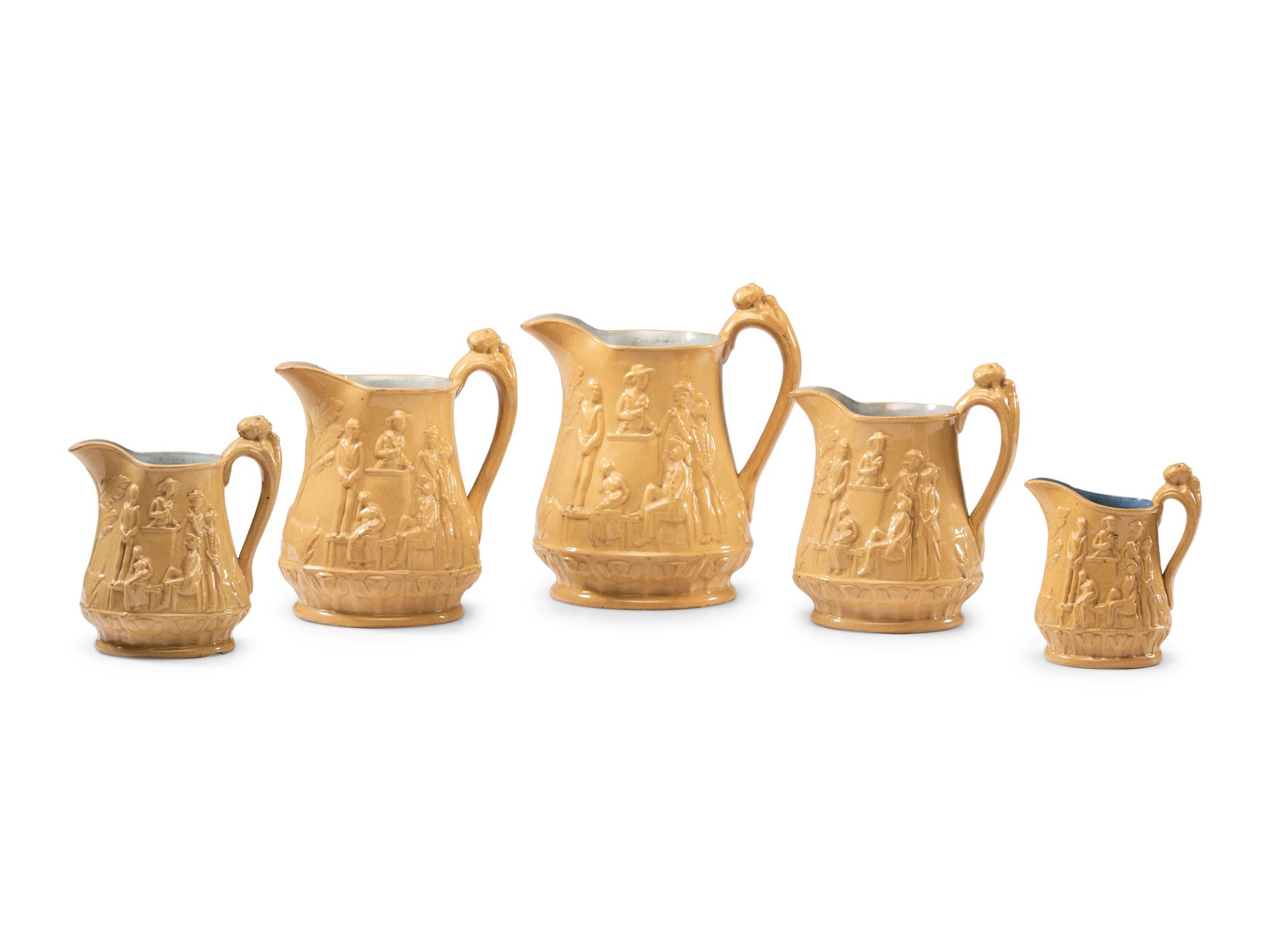 Five Graduated Abolitionist Yellowware Pitchers with Molded Scenes from Uncle Tom's Cabin