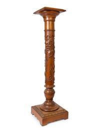 An Italian Carved Walnut Marble-Top Pedestal