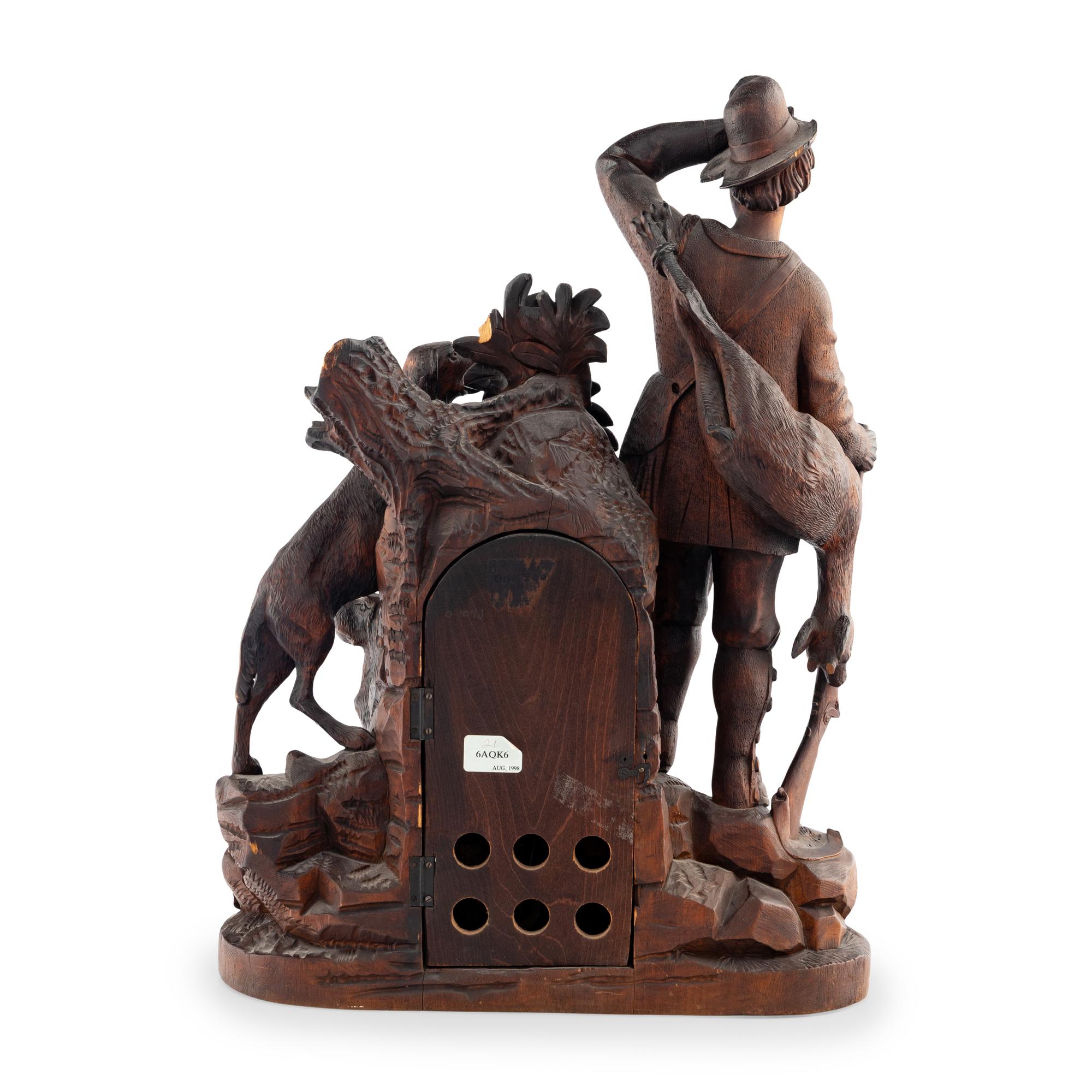 A Swiss "Black Forest" Carved Oak Figural Mantel Clock