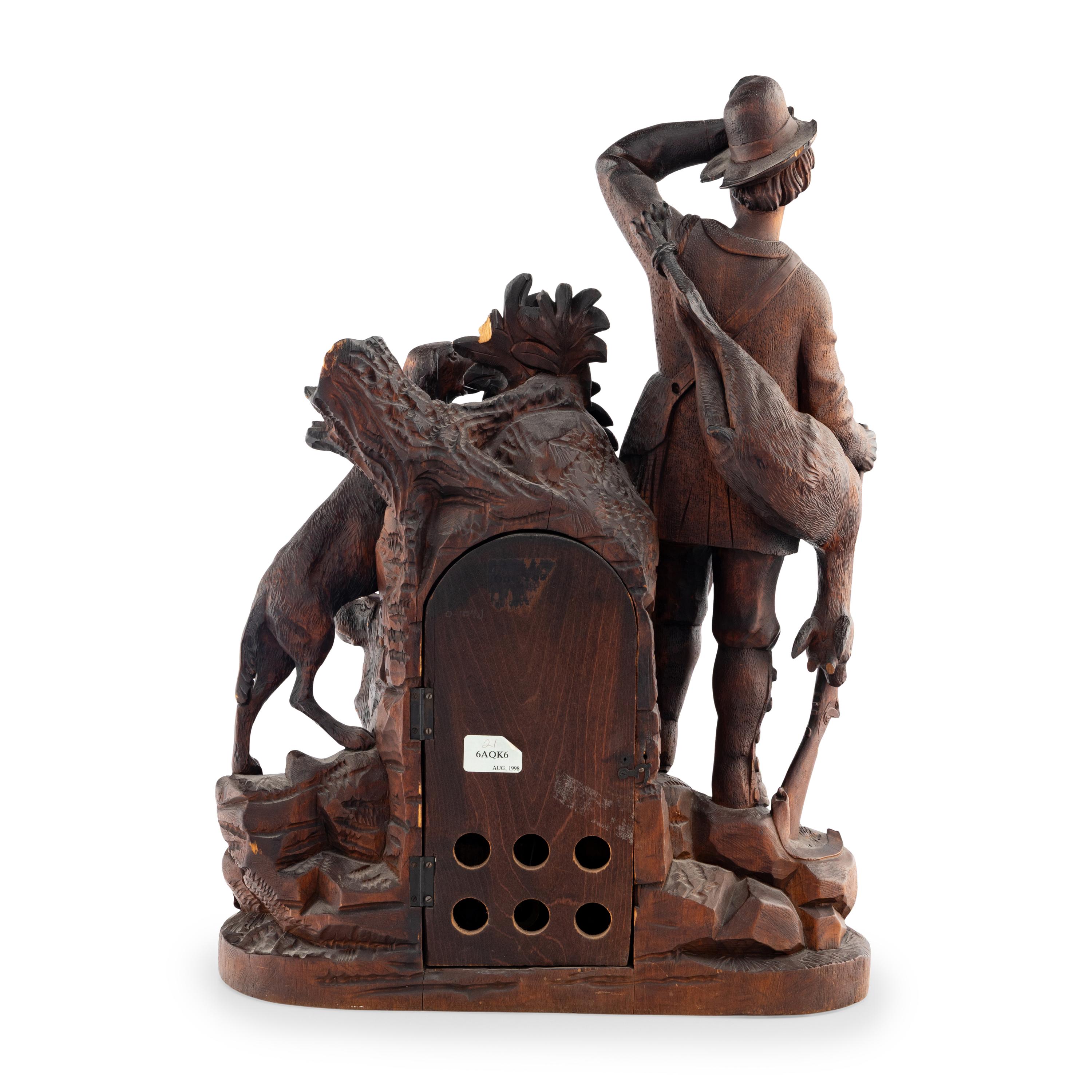 A Swiss "Black Forest" Carved Oak Figural Mantel Clock