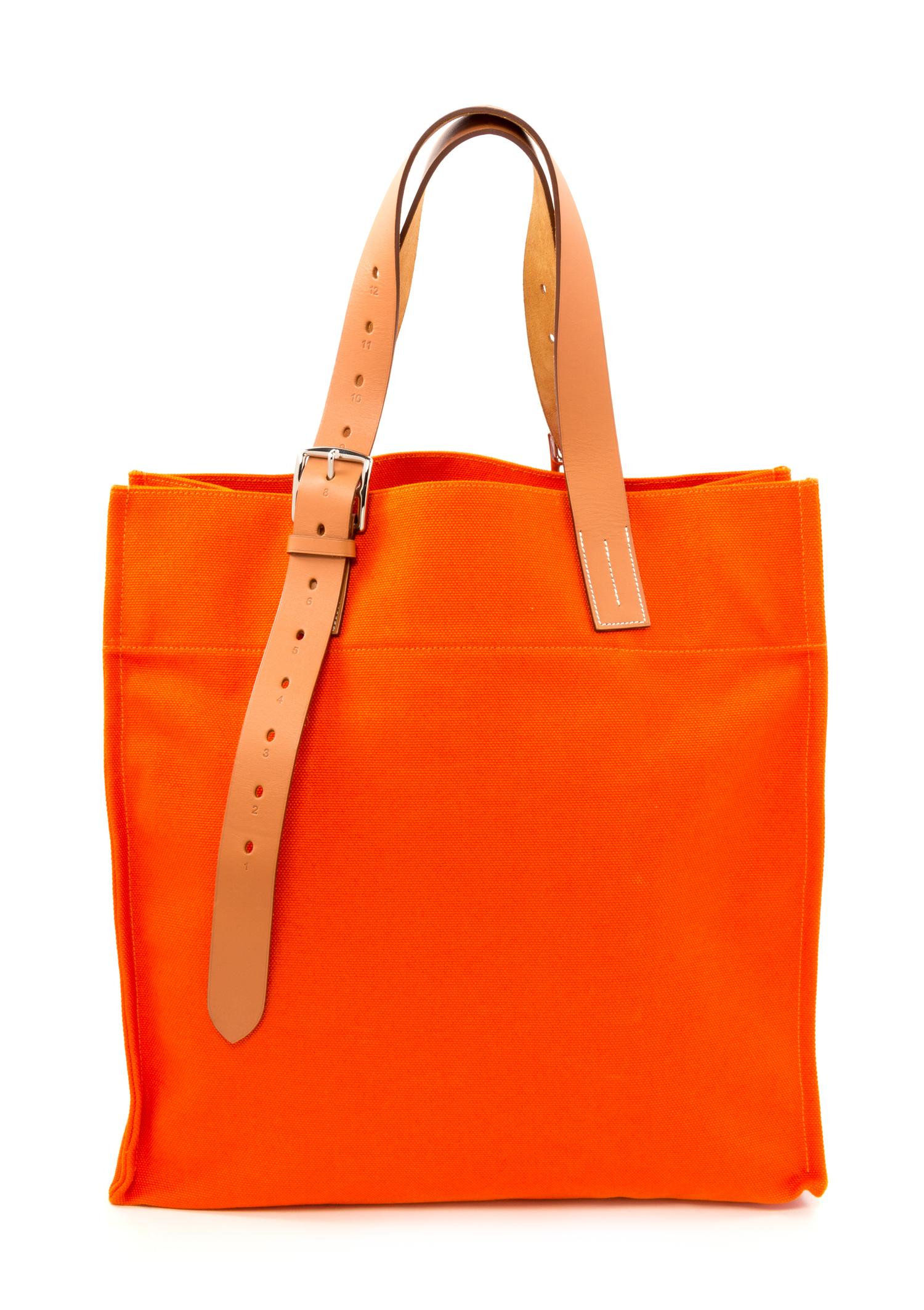 An Hermès Orange Canvas Etiviere Shopping Tote, 16" x 17" x 6"; Strap adjustable to 17".