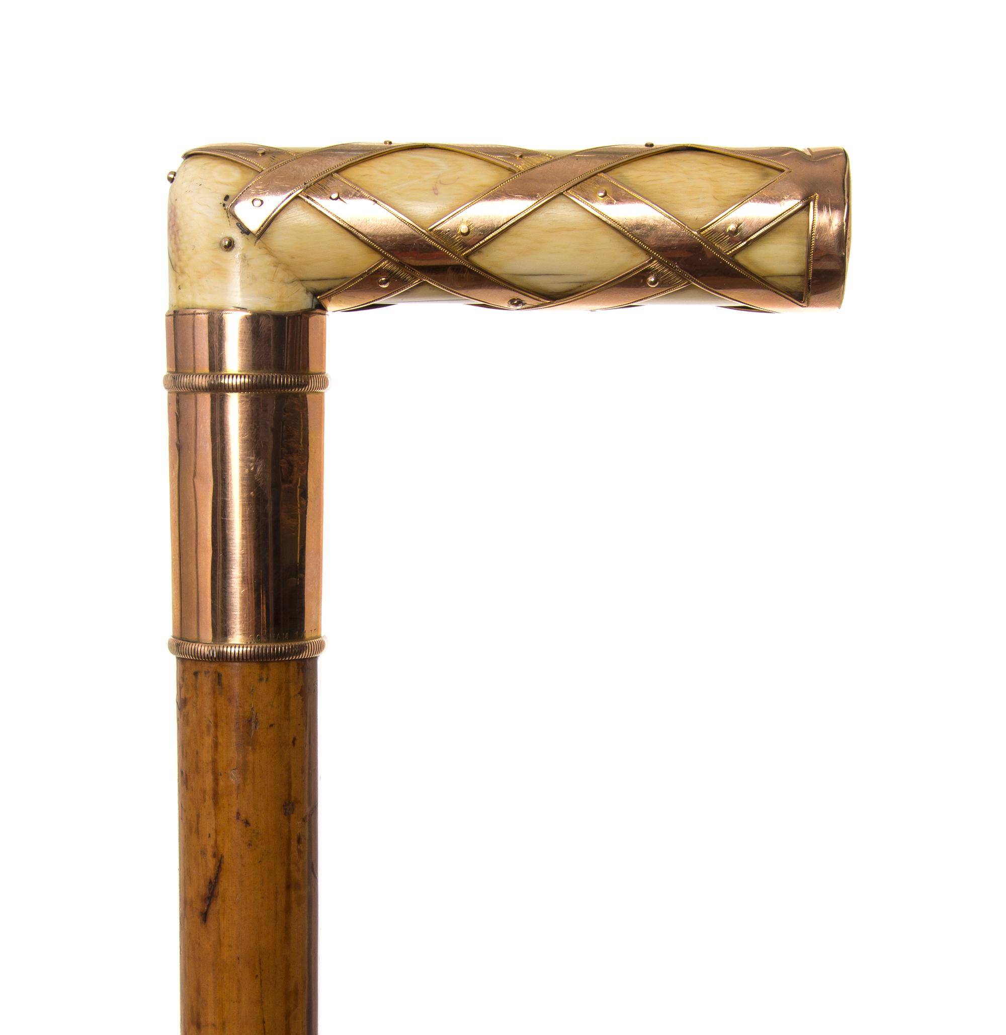 An American Ivory and 14 Karat Gold Handled Cane, Length of handle 2 1/2 x length overall 35 inches.