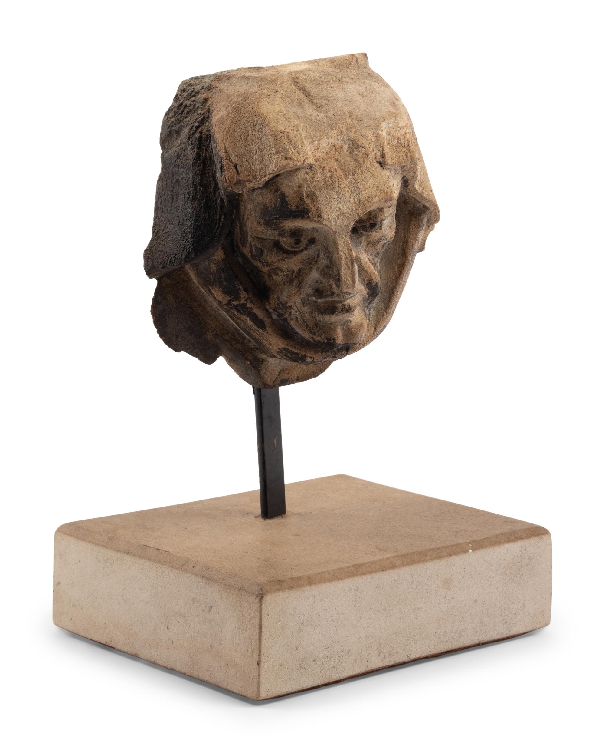 A Continental Carved Stone Head