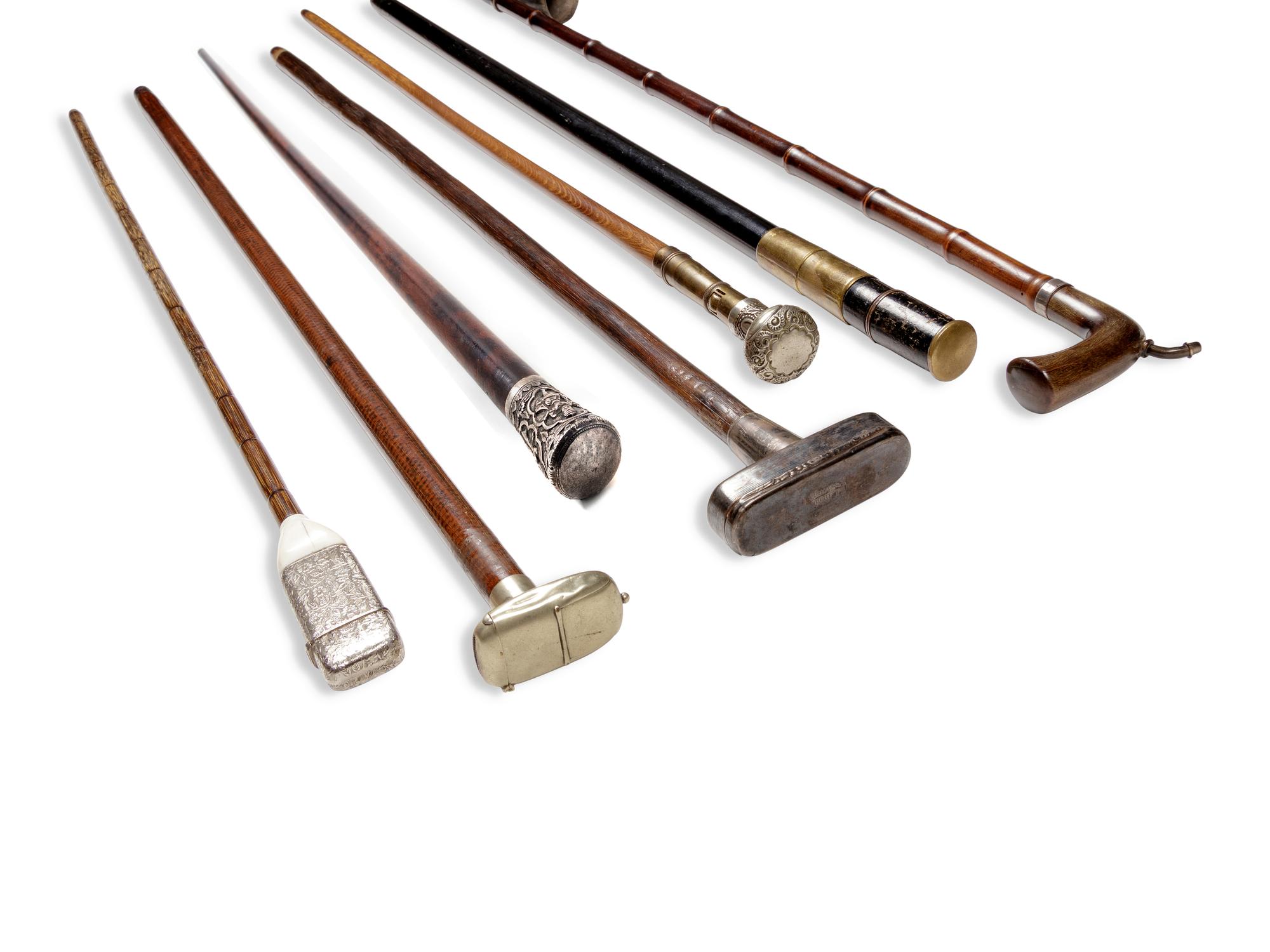 Seven Silvered Metal and Brass Mounted Smoker's System Walking Sticks