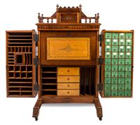 A Wooton Walnut Patent Secretary Desk Height of desk 70 1/2 x width 42 1/2 x depth 31 1/2 inches. — LATE 19TH CENTURY