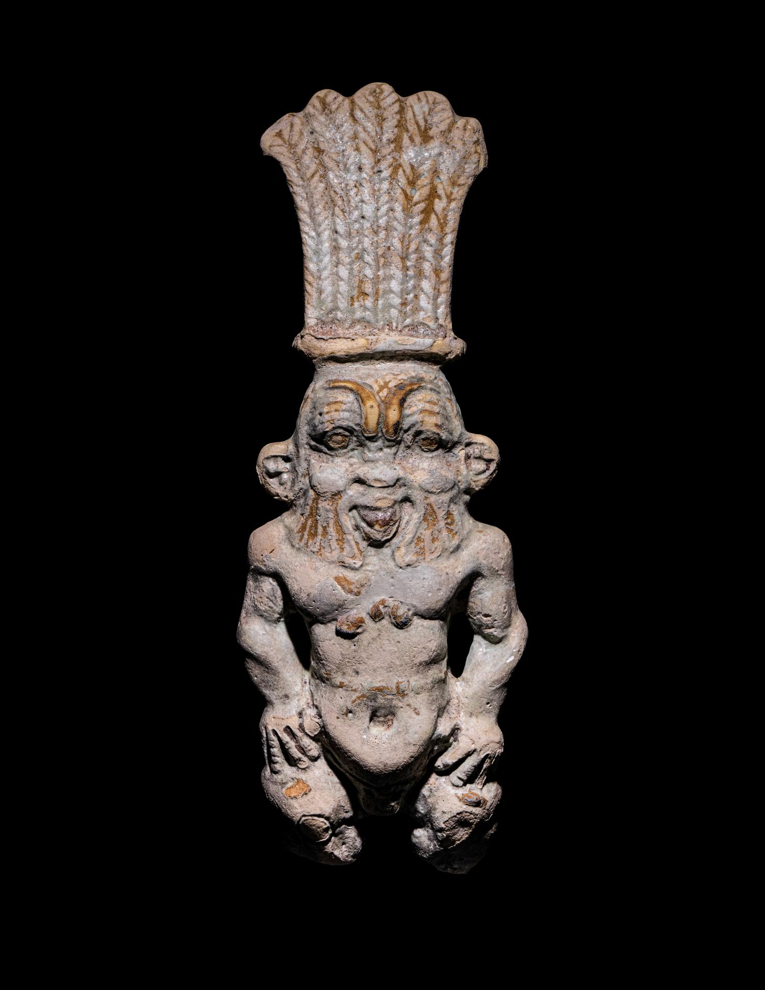 An Egyptian Bichrome Faience Double-Sided Bes