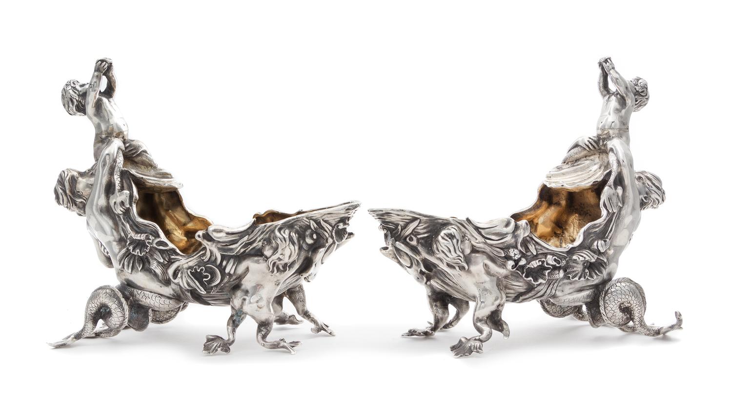 A Pair of Victorian Silver Figural Sauce Boats, Charles Stuart Harris, London, 1879, each surmounted by a merchild blowing a conch shel