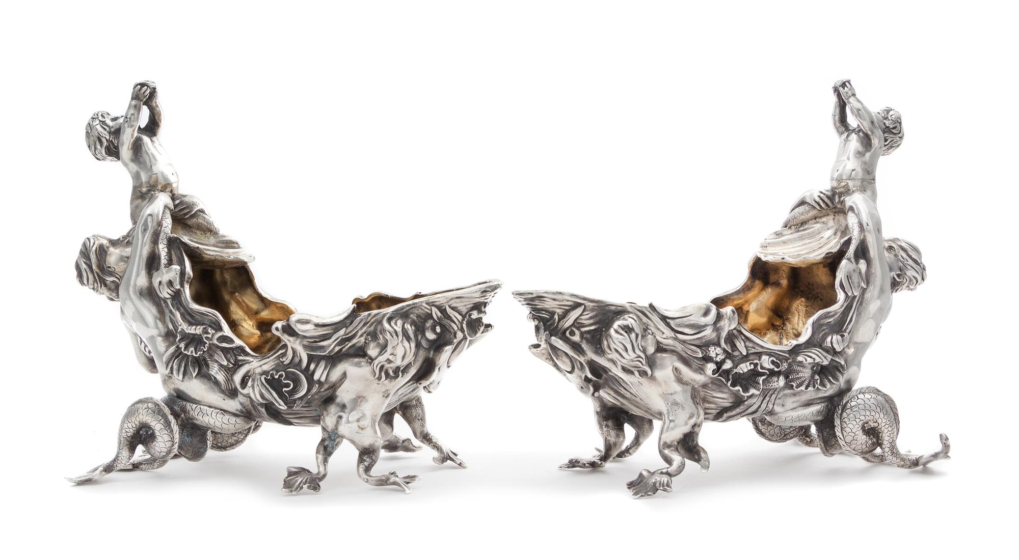 A Pair of Victorian Silver Figural Sauce Boats, Charles Stuart Harris, London, 1879, each surmounted by a merchild blowing a conch shel