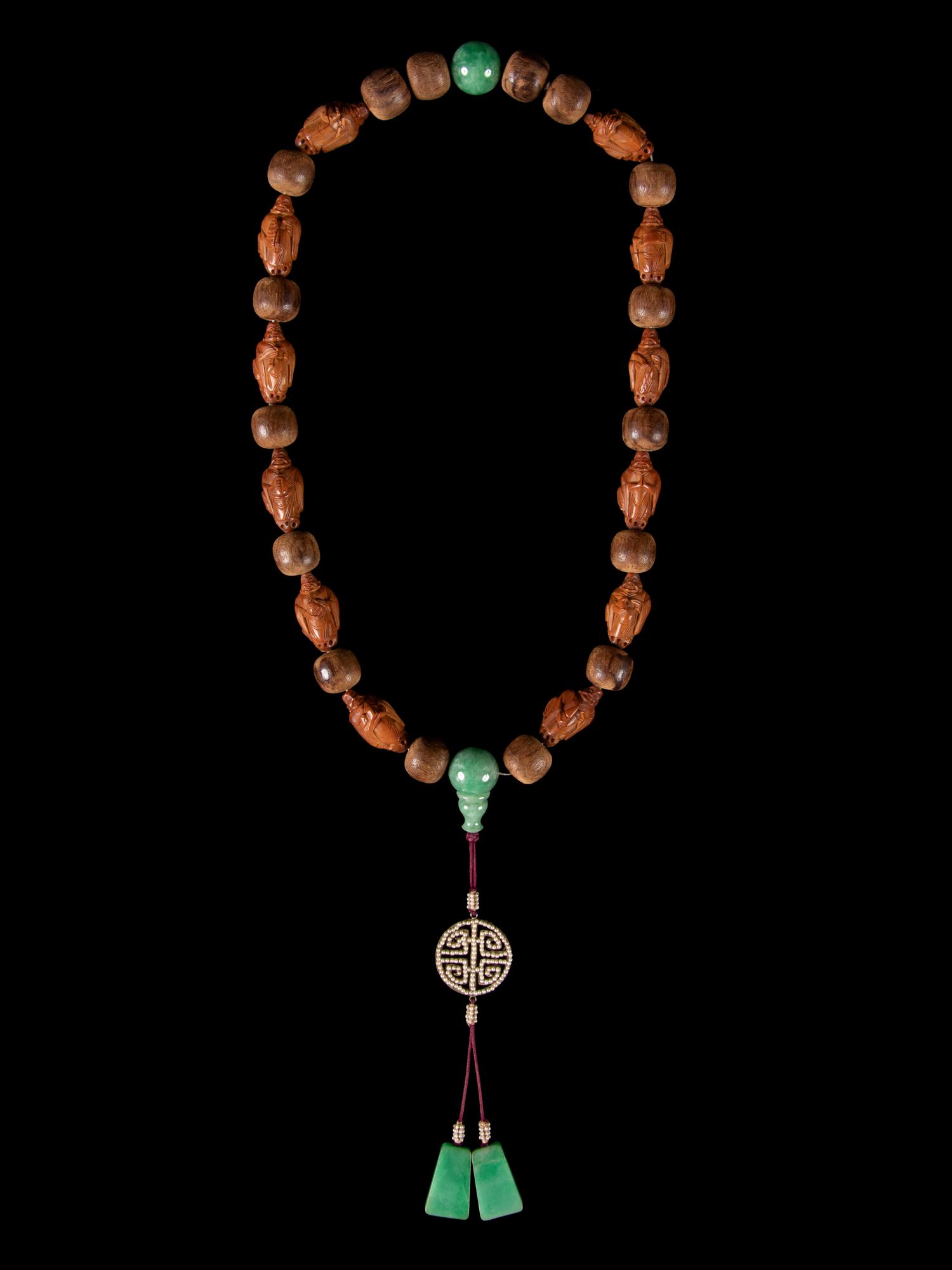 A Jadeite and Nut Bead Necklace