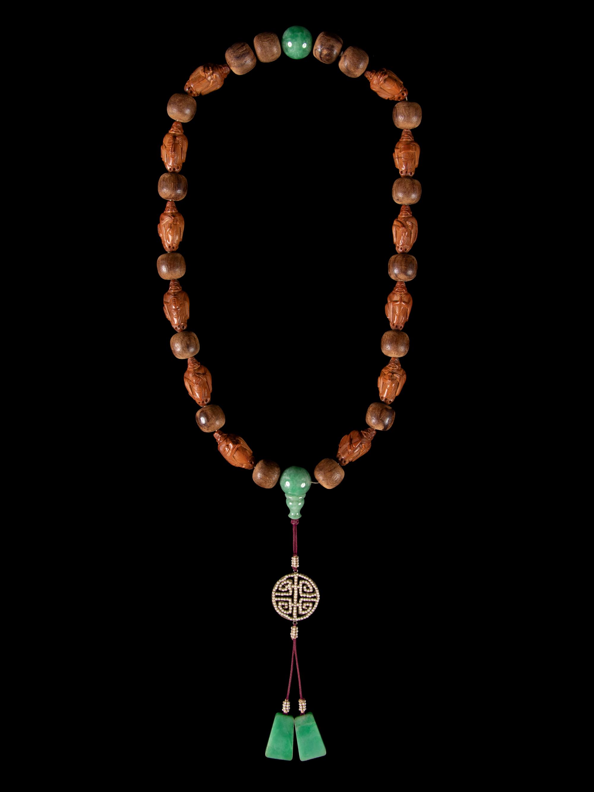 A Jadeite and Nut Bead Necklace