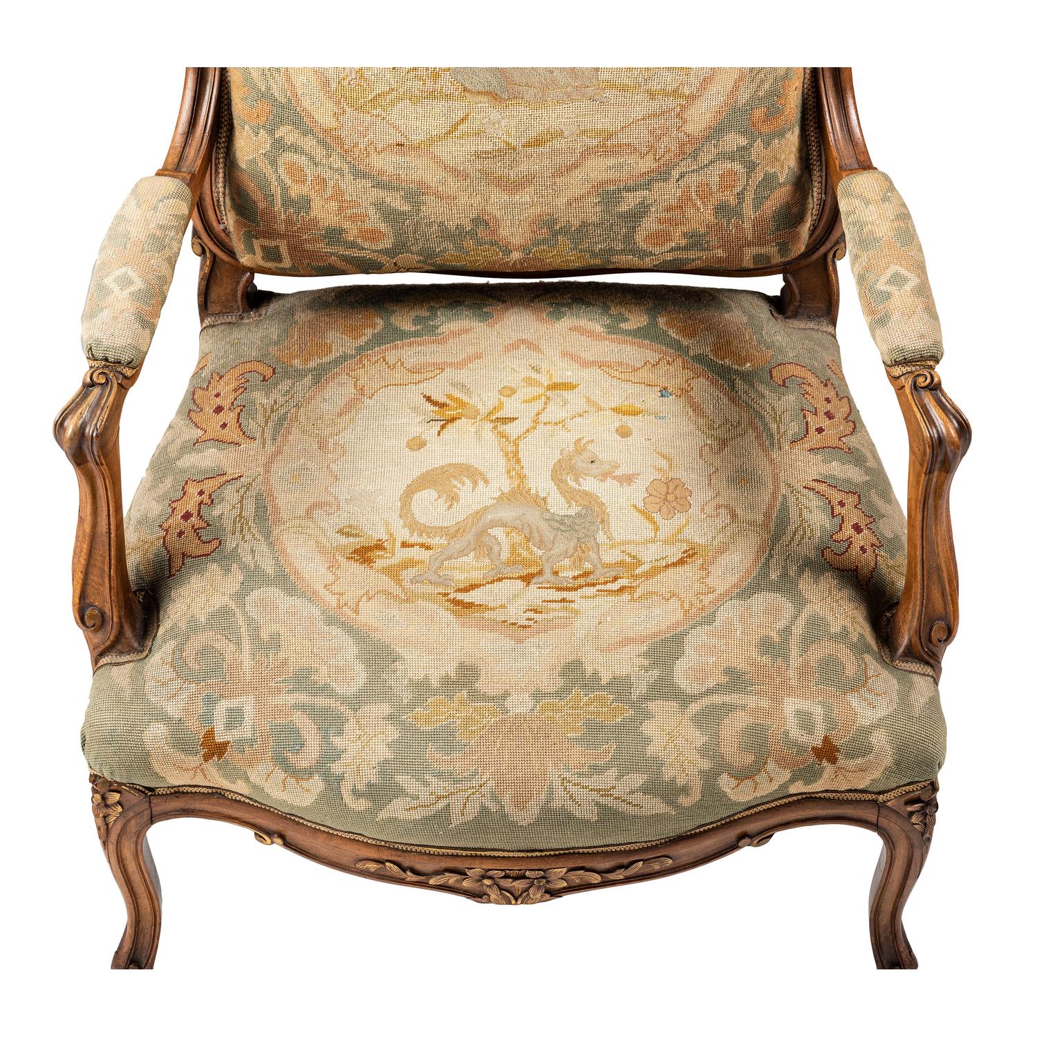 A Louis XV Style Carved Walnut and Needlework Upholstered Fauteuil