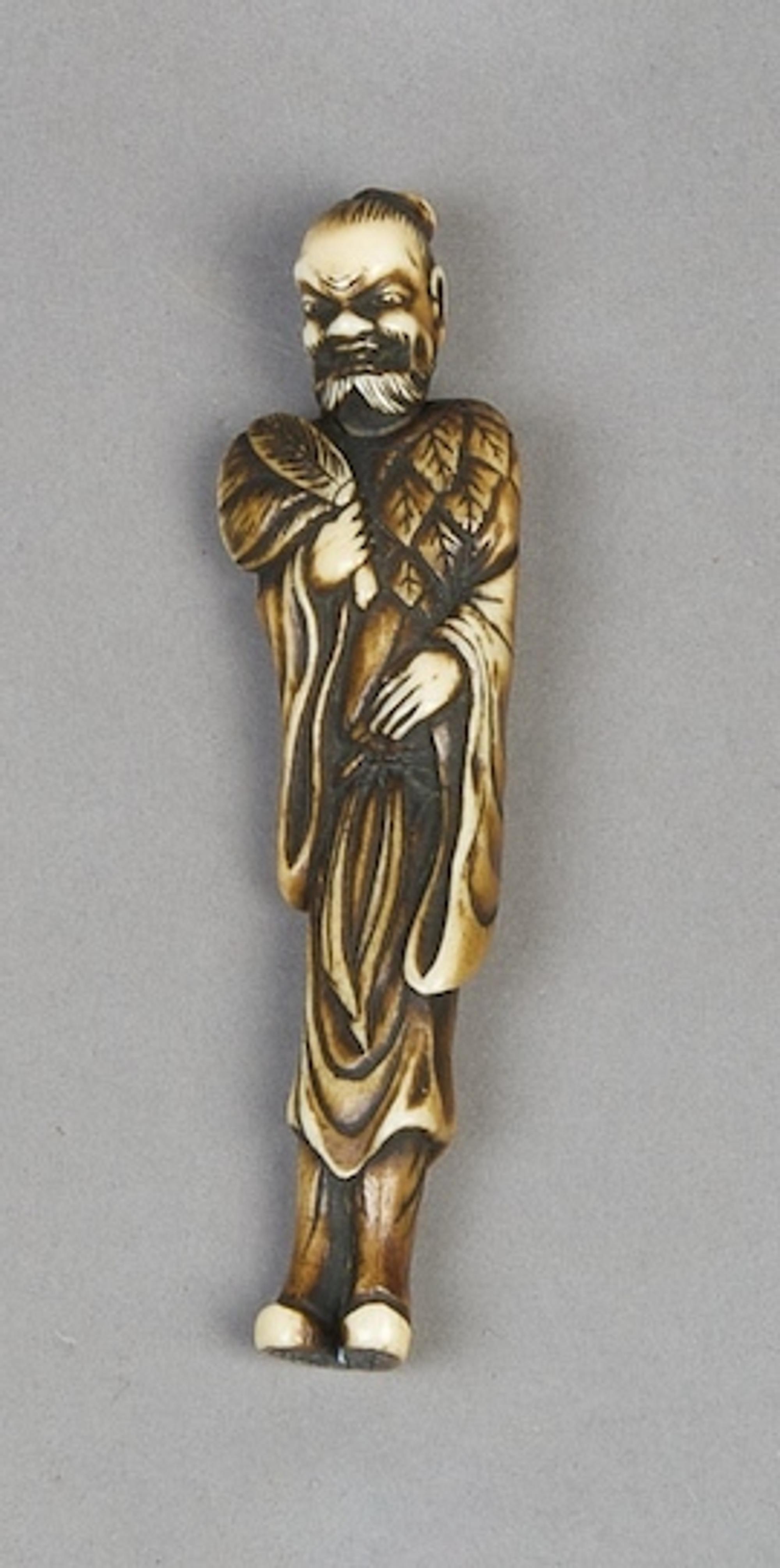 An Ivory Netsuke of a Man, Height 3 7/8 inches.