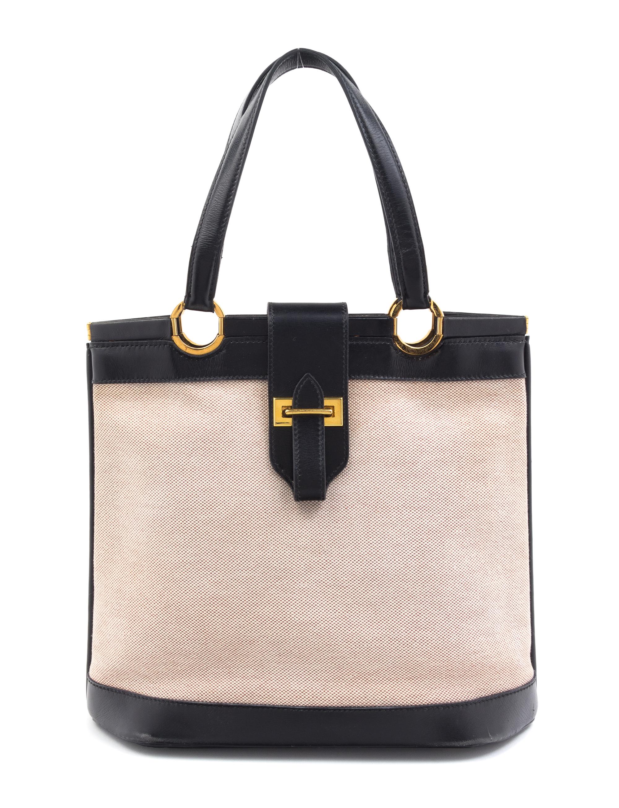 An Hermes Black Leather and Canvas Handbag, 10" x 12" x 3".