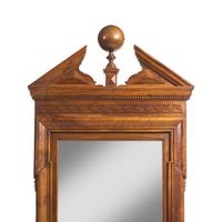 A Large Neoclassical Carved Walnut Mirror