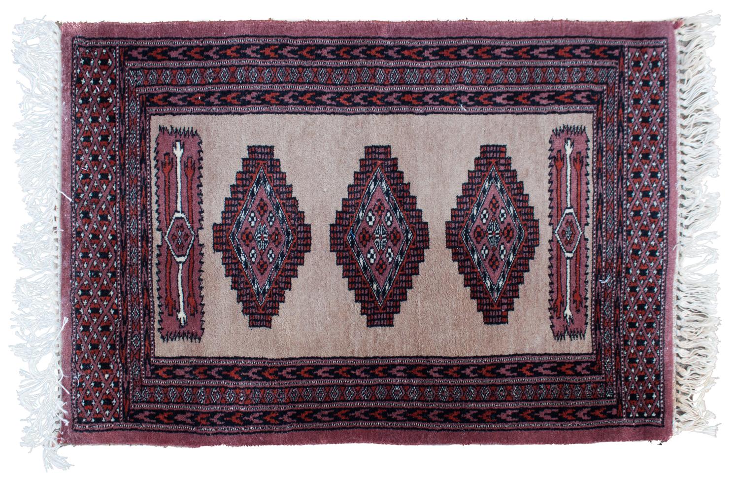 A Wool Rug 3 feet x 2 feet 1/2 inches.
