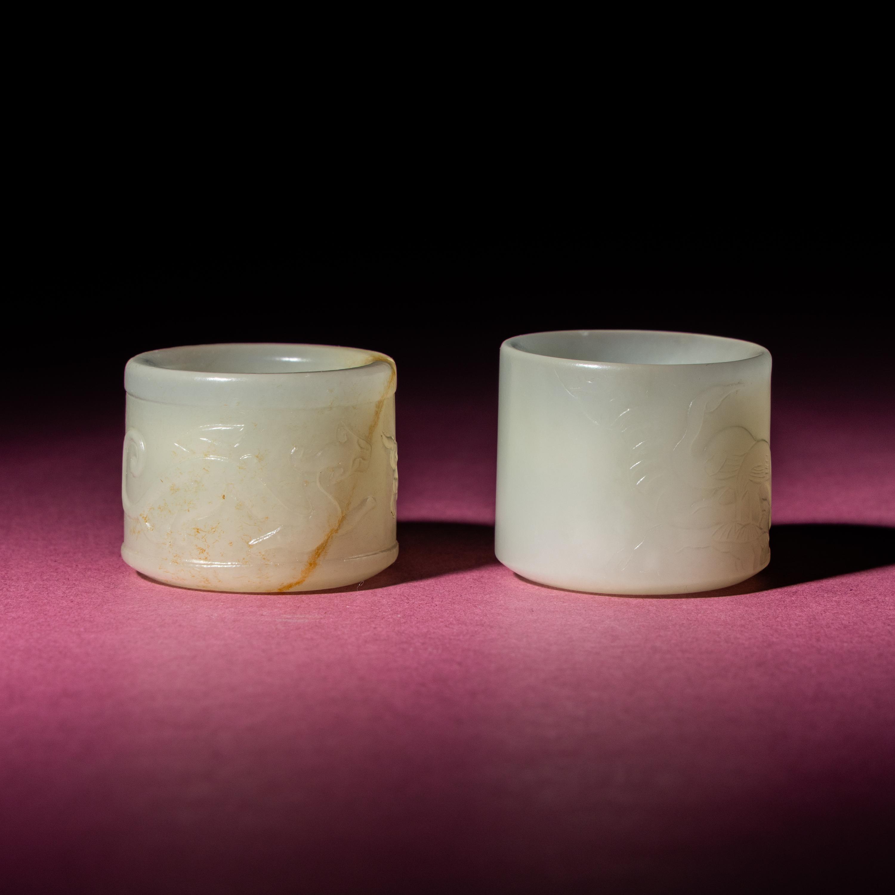 Two Chinese White Jade 'Animal' Archer's Rings, 18th Century — 清中期 白玉刻動物紋扳指兩枚