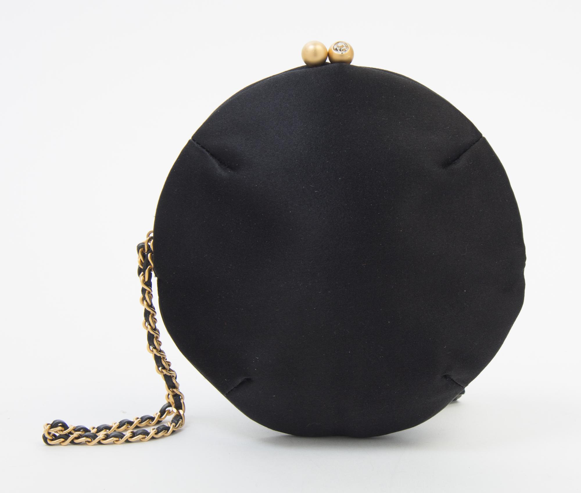 A Chanel Black Silk Embroidered Rhinestone Circular Clutch, 7" diameter.
