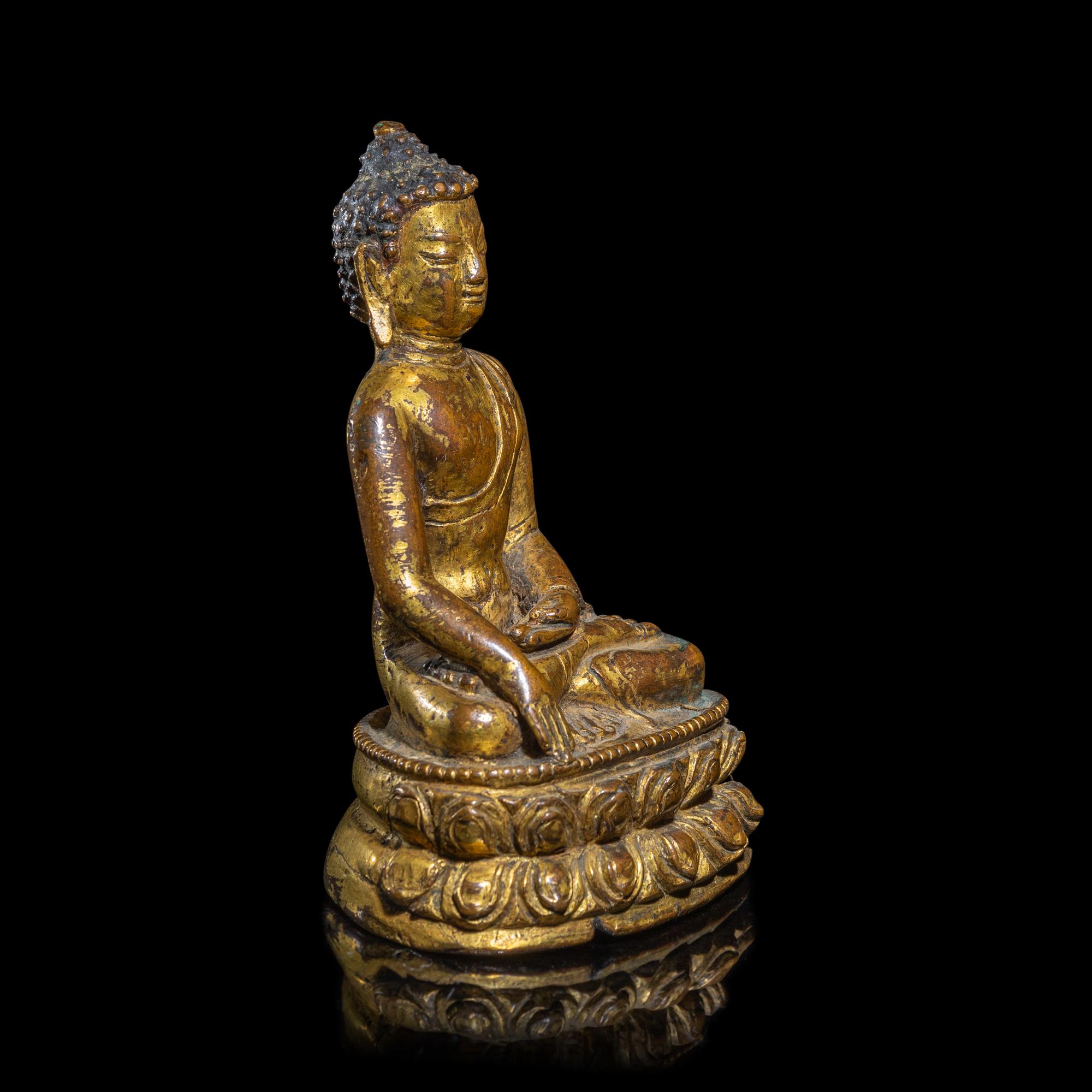 A Tibetan Gilt Copper Alloy Figure of Buddha Shakyamuni, 15th/16th Century 十五/十六世紀 西藏銅鎏金坐佛