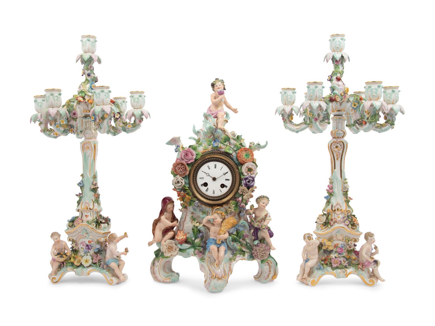 A Meissen Porcelain Clock Garniture and Clock Stand