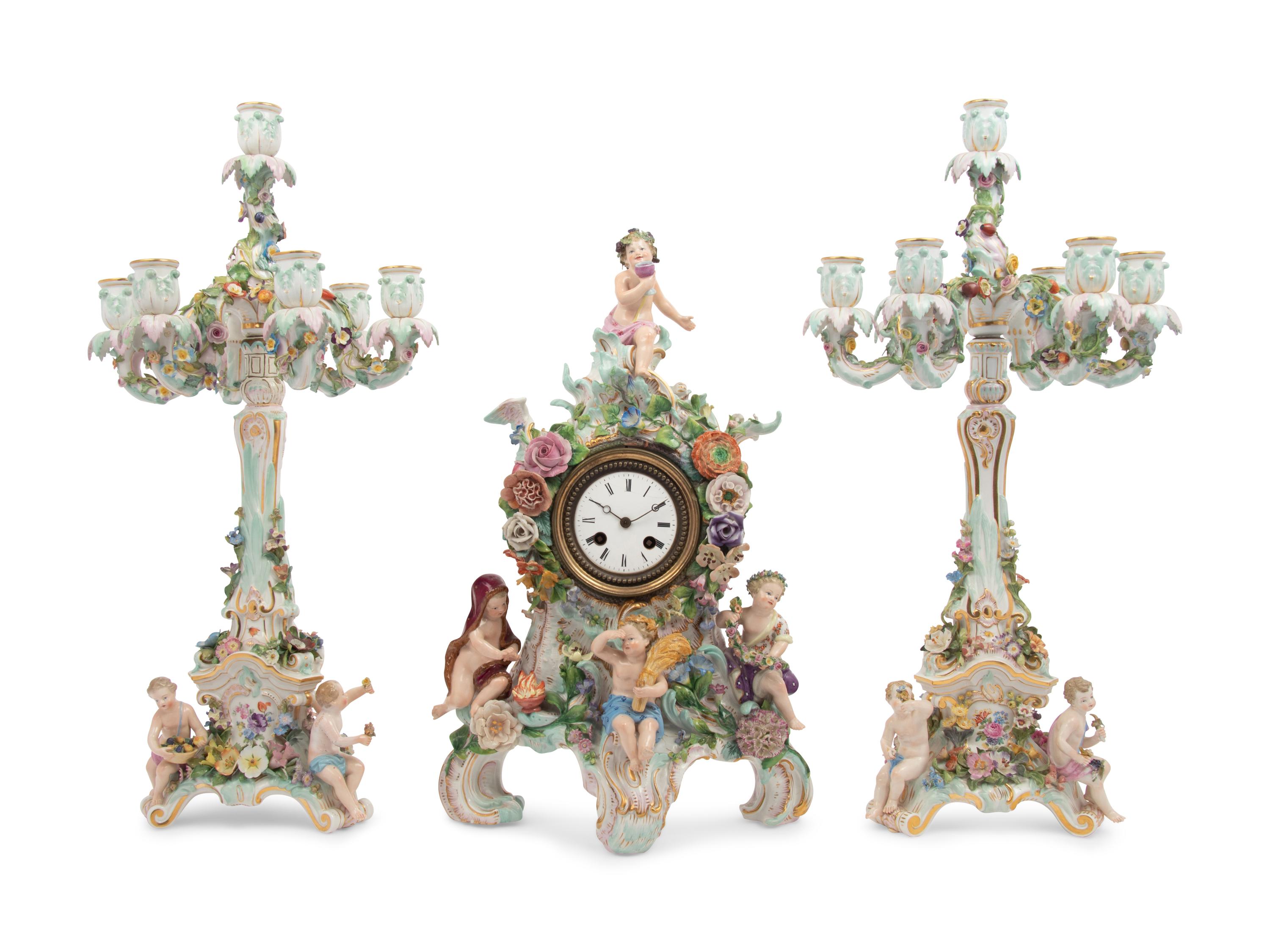 A Meissen Porcelain Clock Garniture and Clock Stand