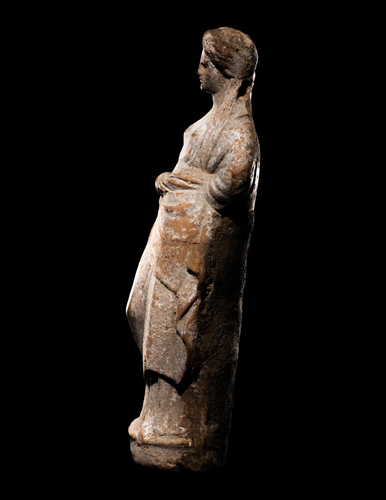 A Greek Terracotta Standing Draped Female Deity