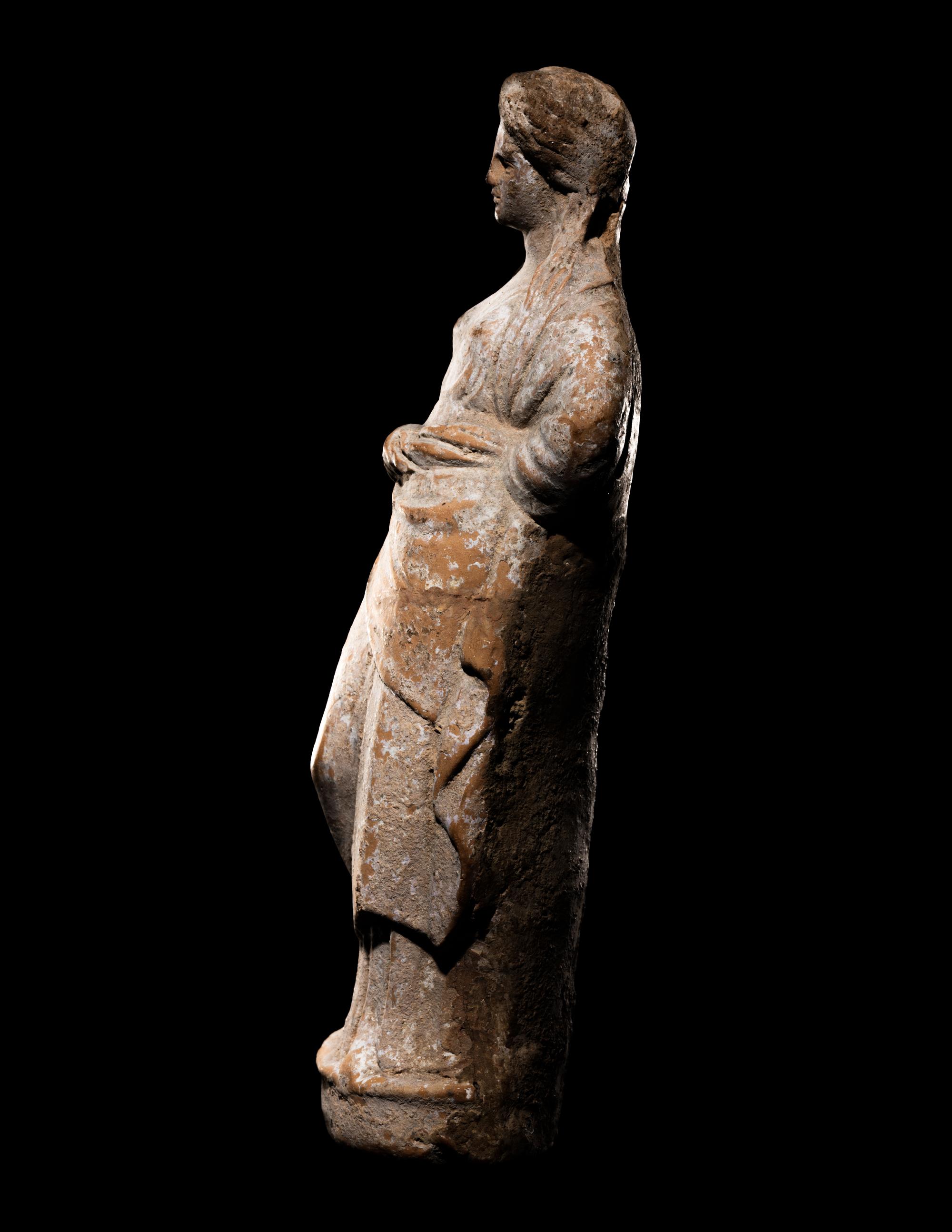 A Greek Terracotta Standing Draped Female Deity