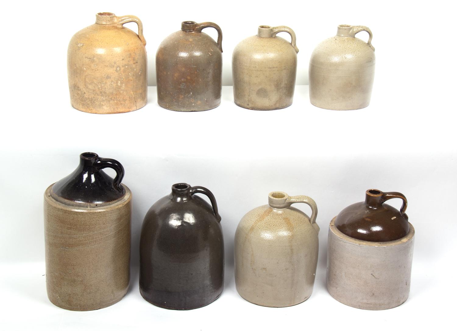 A Collection of Eight Stoneware Whiskey Jugs Height of tallest 16 1/2 inches.