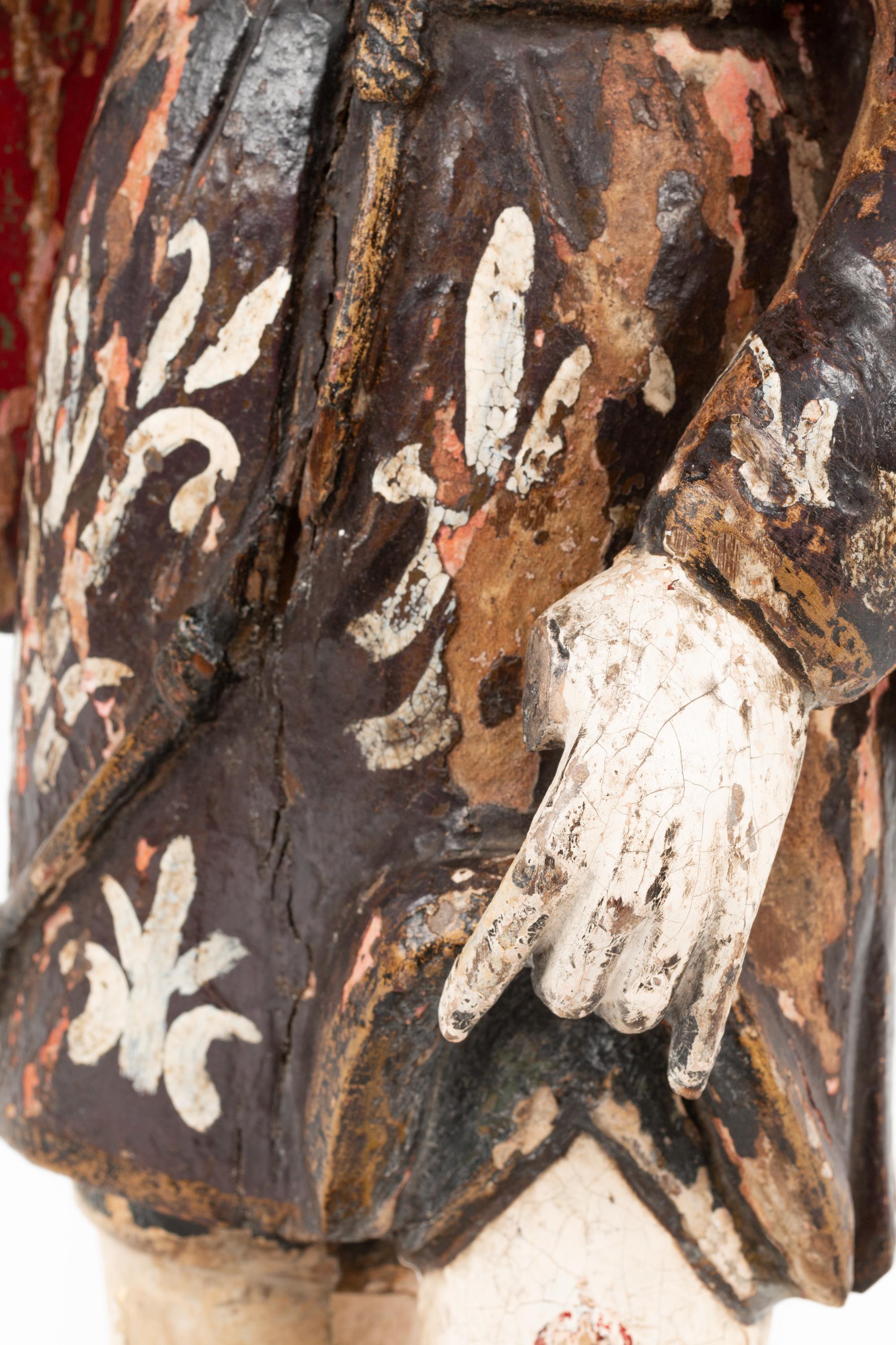 A Continental Painted Figure of a Saint with a Dog