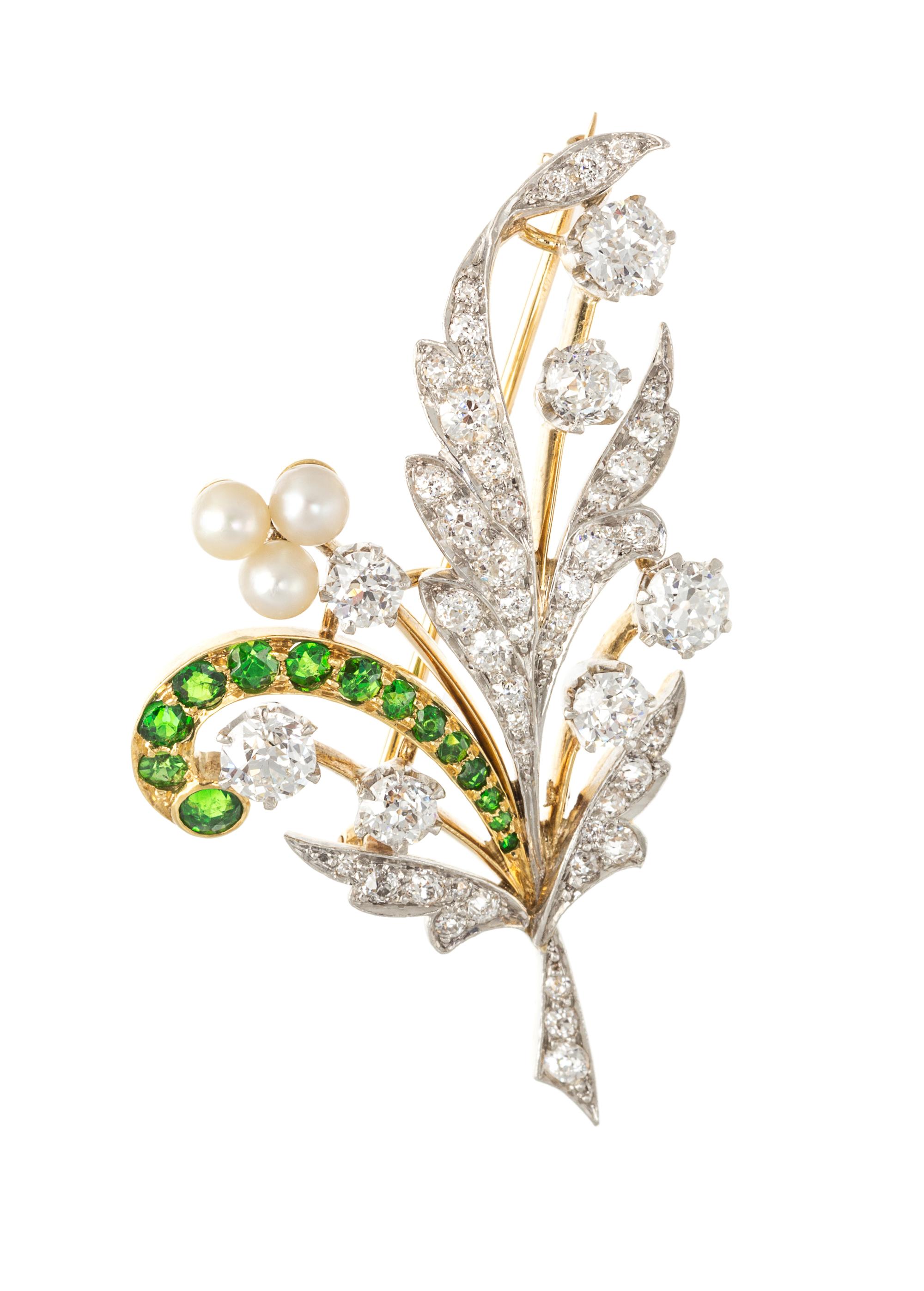 An Edwardian Platinum Topped Gold, Diamond, Demantoid Garnet and Pearl Foliate Motif Brooch, 8.00 dwts.