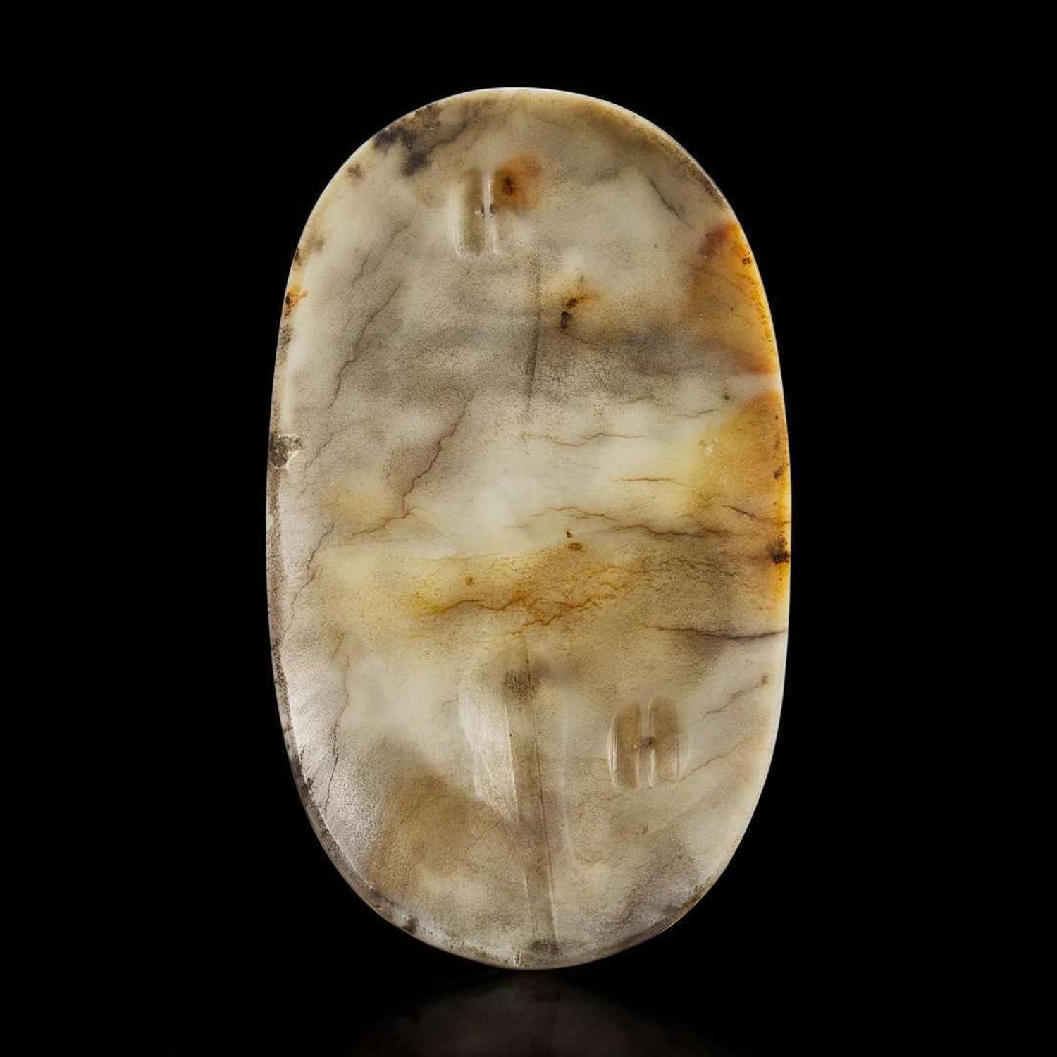 A Chinese carved jade oval plaque with a figure of Liu Hai in a landscape 松下童子白玉牌饰 18th / 19th century ???????