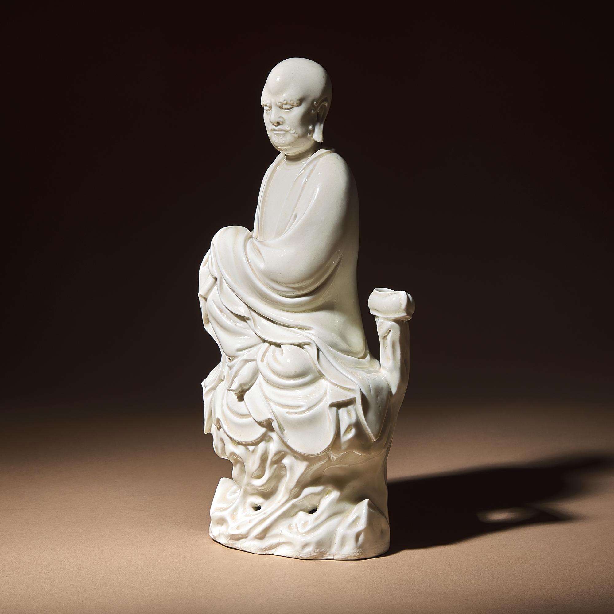 A Chinese Blanc-de-Chine Porcelain Seated Figure of Damo with 'He Chaozong' Mark, Qing Dynasty — 清 何朝宗款“隻履西歸”德化白瓷達摩坐像