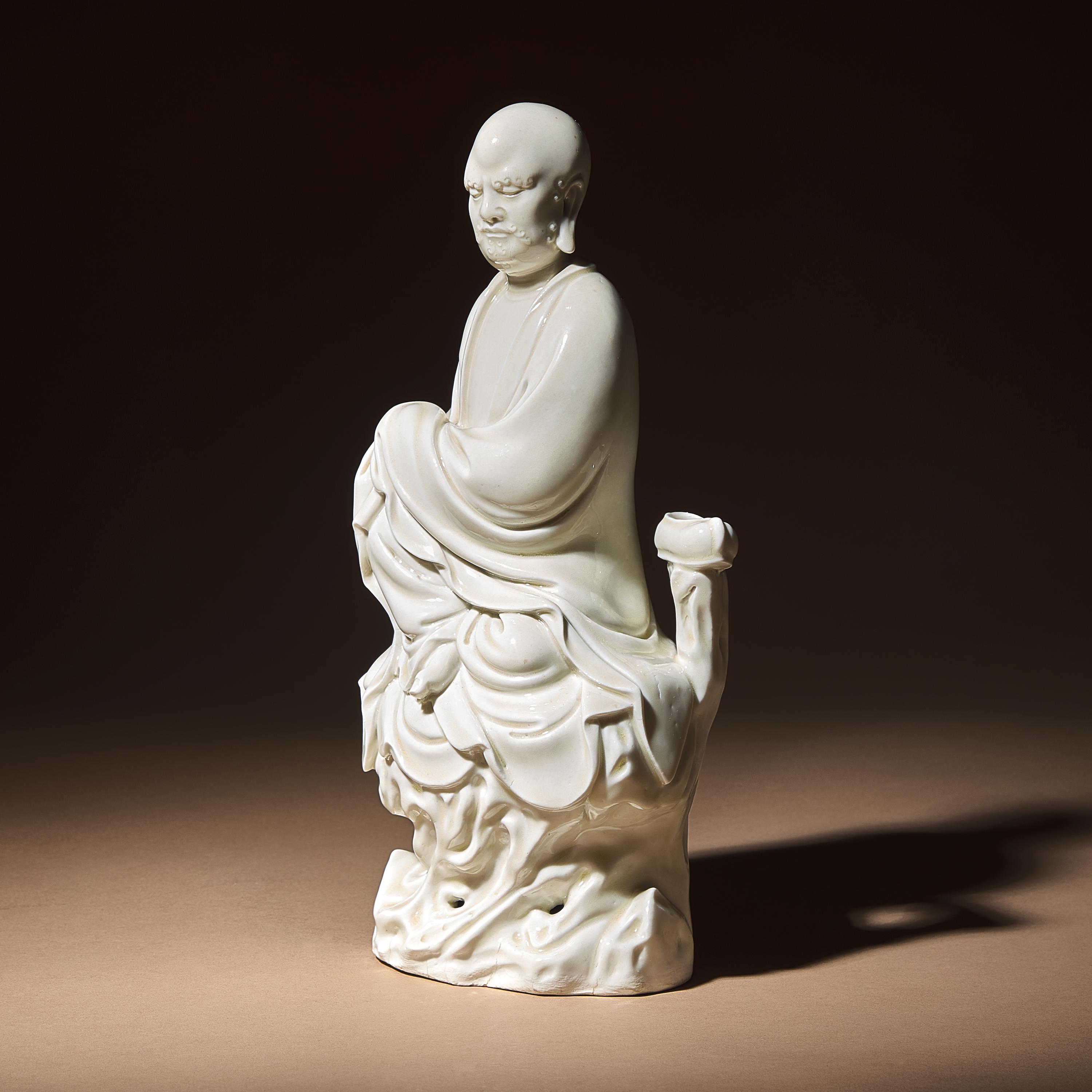 A Chinese Blanc-de-Chine Porcelain Seated Figure of Damo with 'He Chaozong' Mark, Qing Dynasty — 清 何朝宗款“隻履西歸”德化白瓷達摩坐像