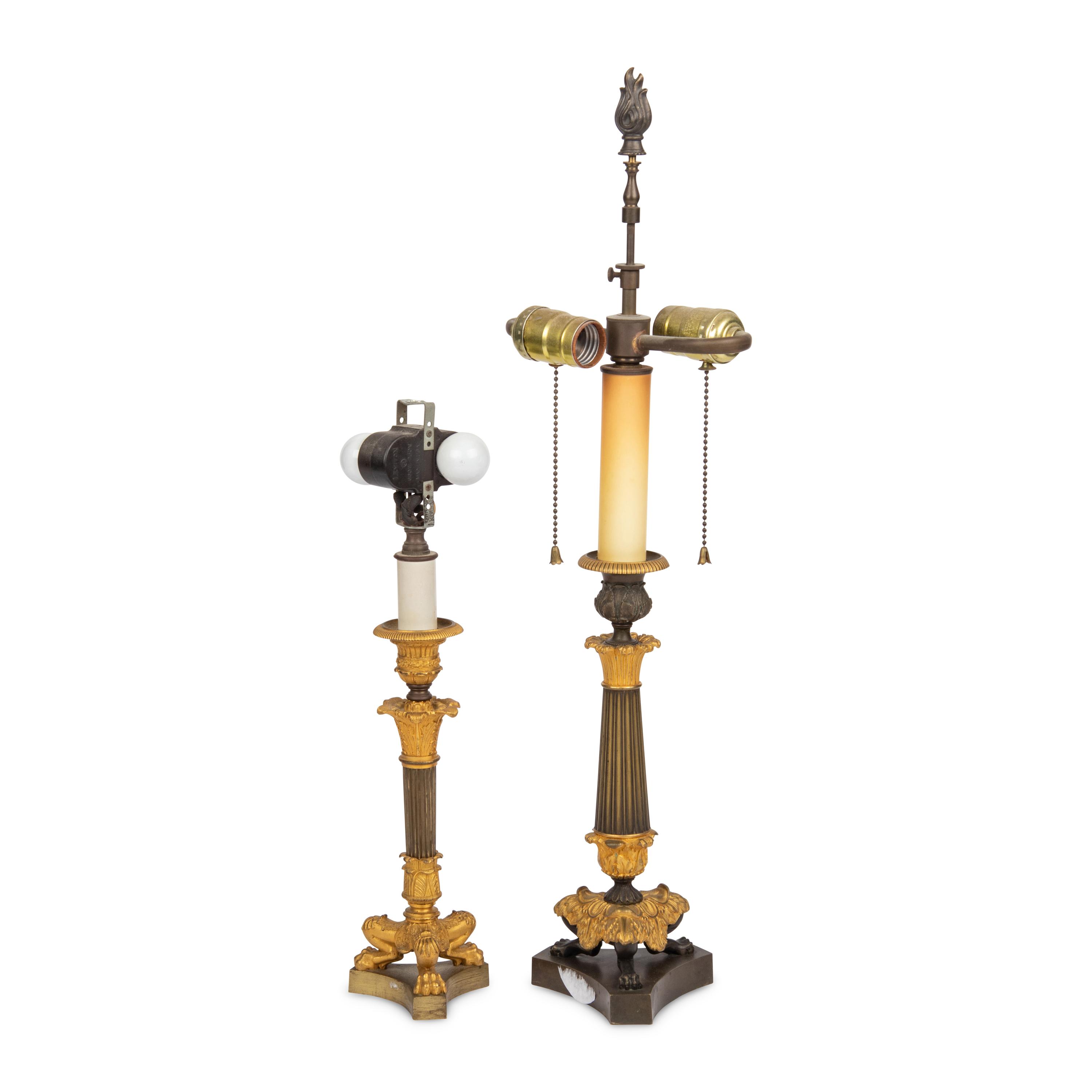 A Group of Two French Empire Style Parcel-Gilt Bronze Candlesticks Mounted as Lamps