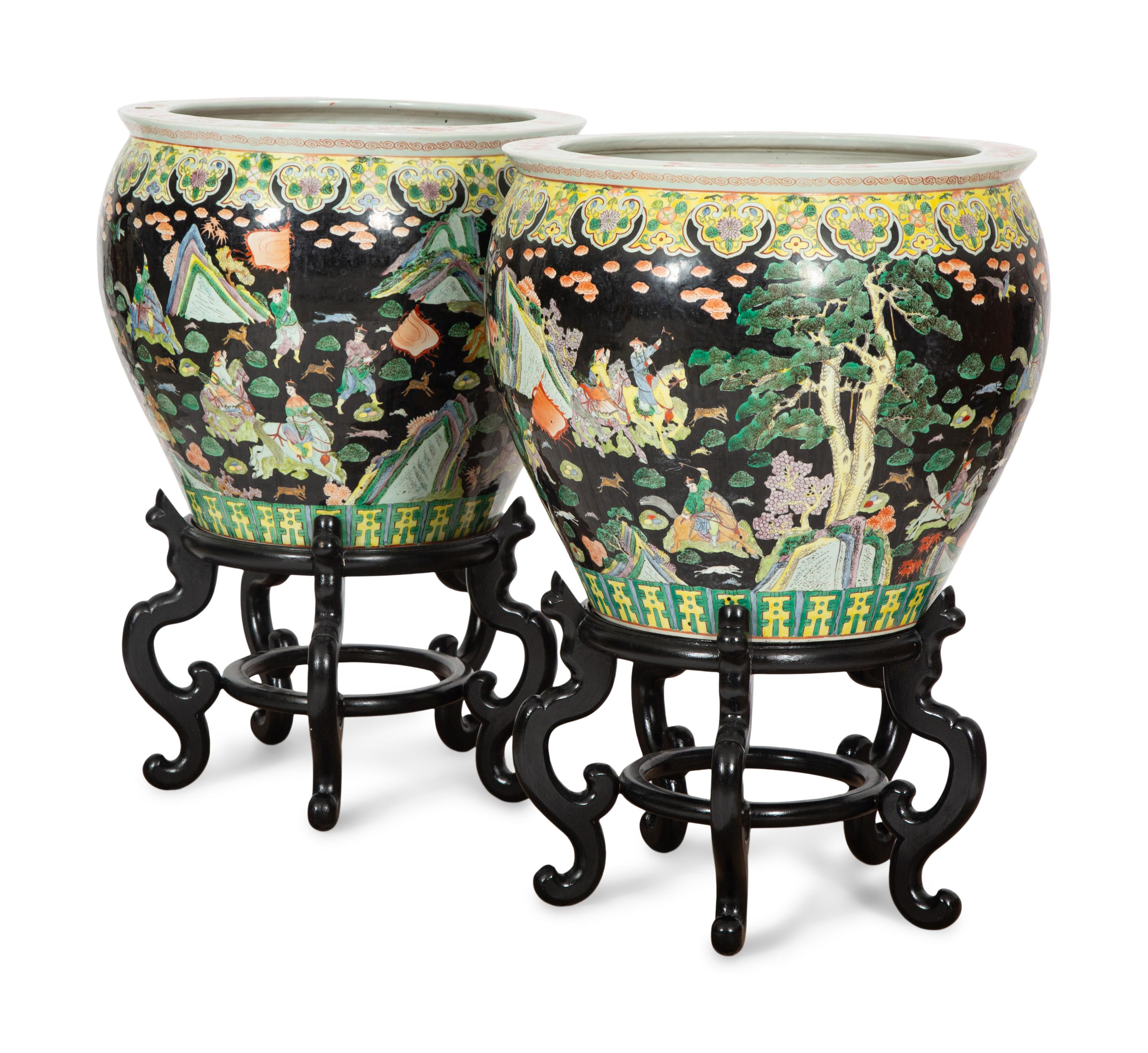 A Pair of Large Famille Noir Porcelain Fish Bowls on Teak Stands