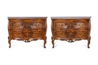 A Pair of Louis XV Style Walnut Bombé Form Commodes