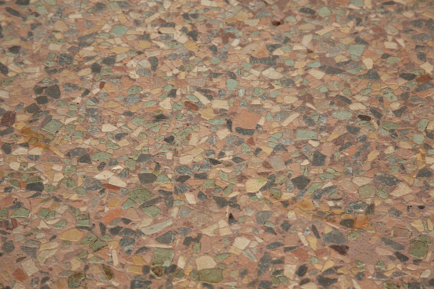 A Cast Iron Base Table with Stone Inset Concrete Top
