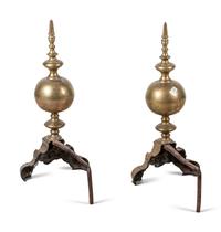 A Pair of Continental Brass Andirons with Masks