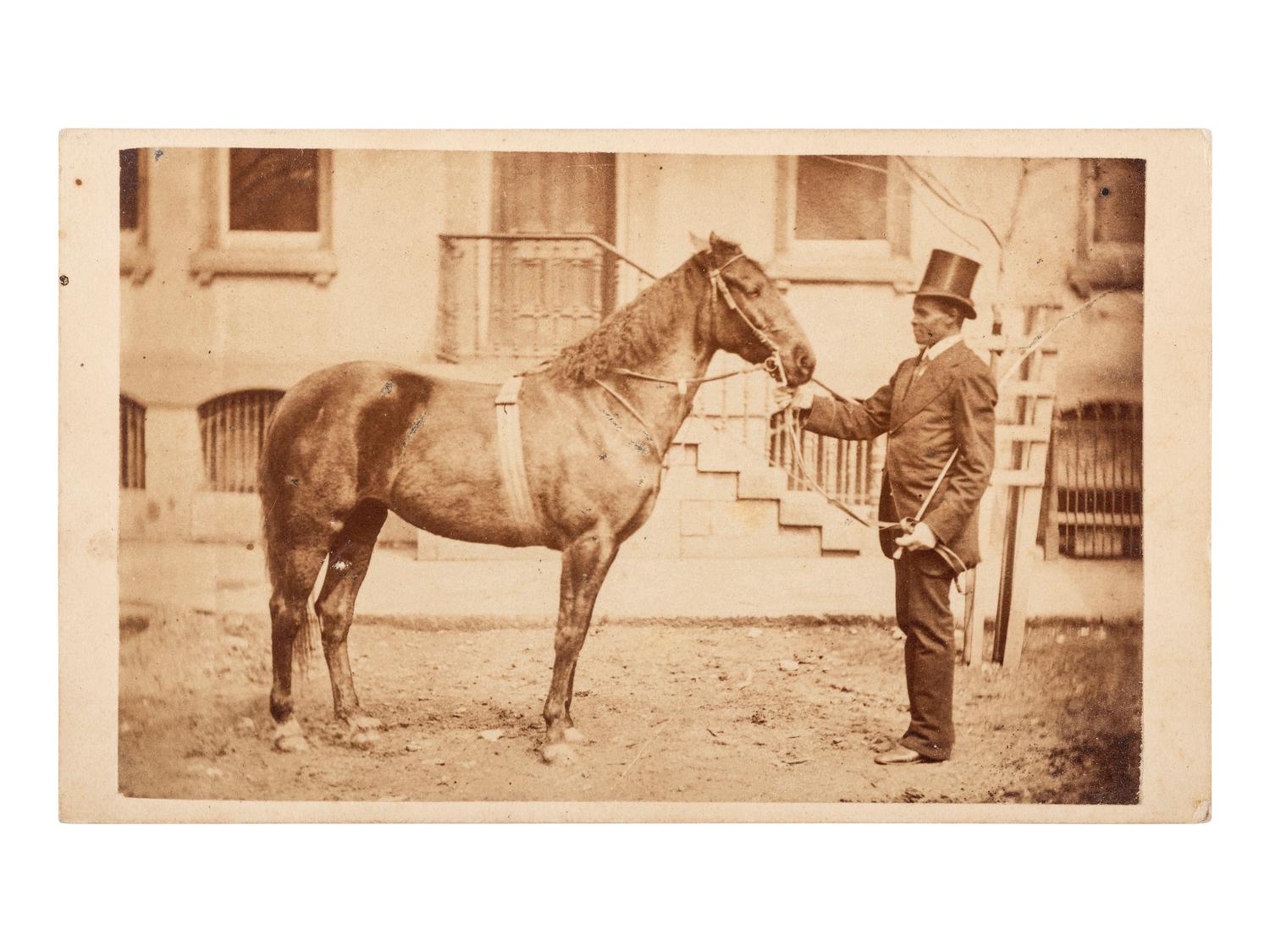 [AFRICAN AMERICANA - EARLY PHOTOGRAPHY]. CDV of an African American man with horse. Bellefonte, PA: J.W. Moore.
