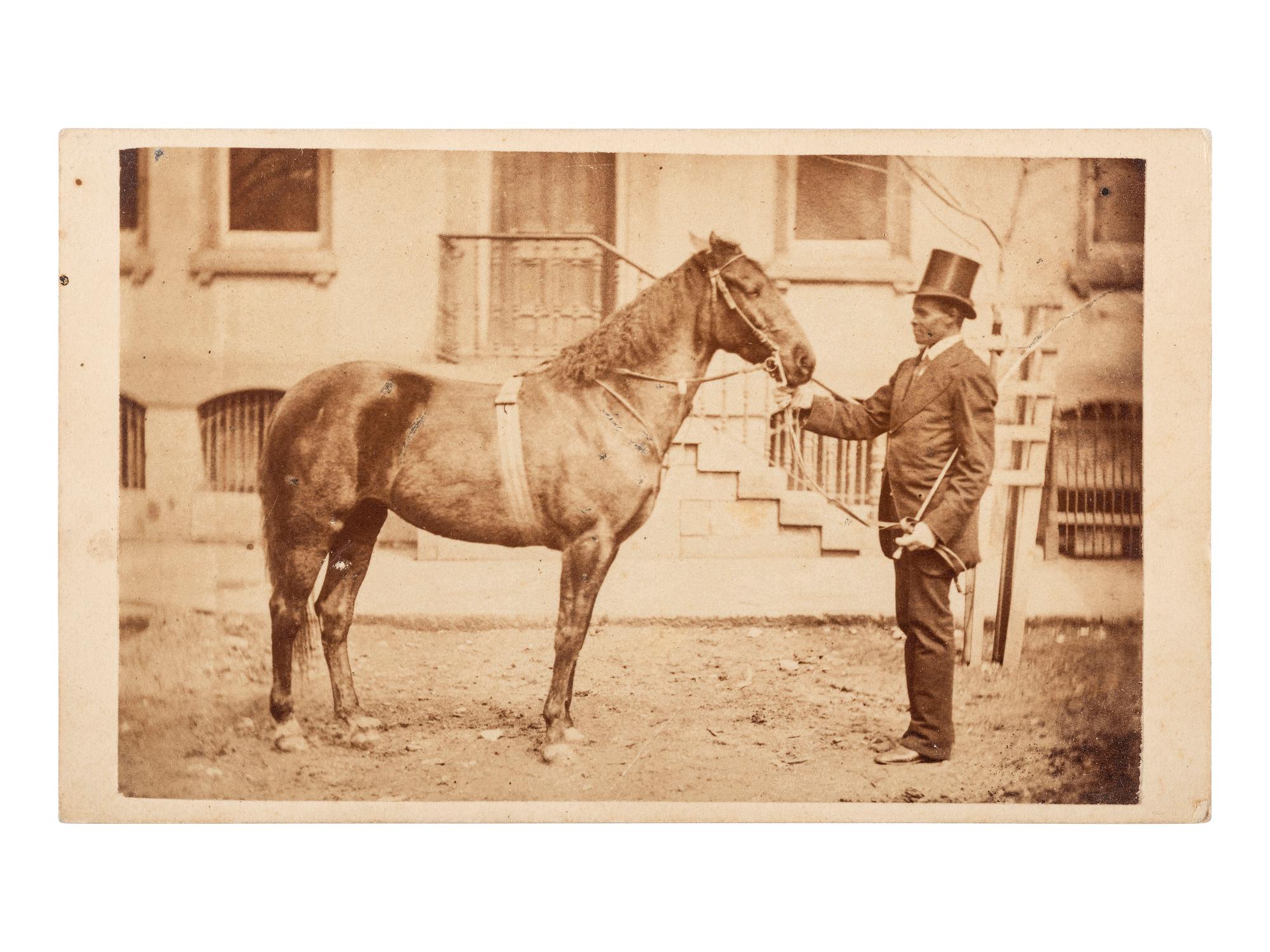 [AFRICAN AMERICANA - EARLY PHOTOGRAPHY]. CDV of an African American man with horse. Bellefonte, PA: J.W. Moore.