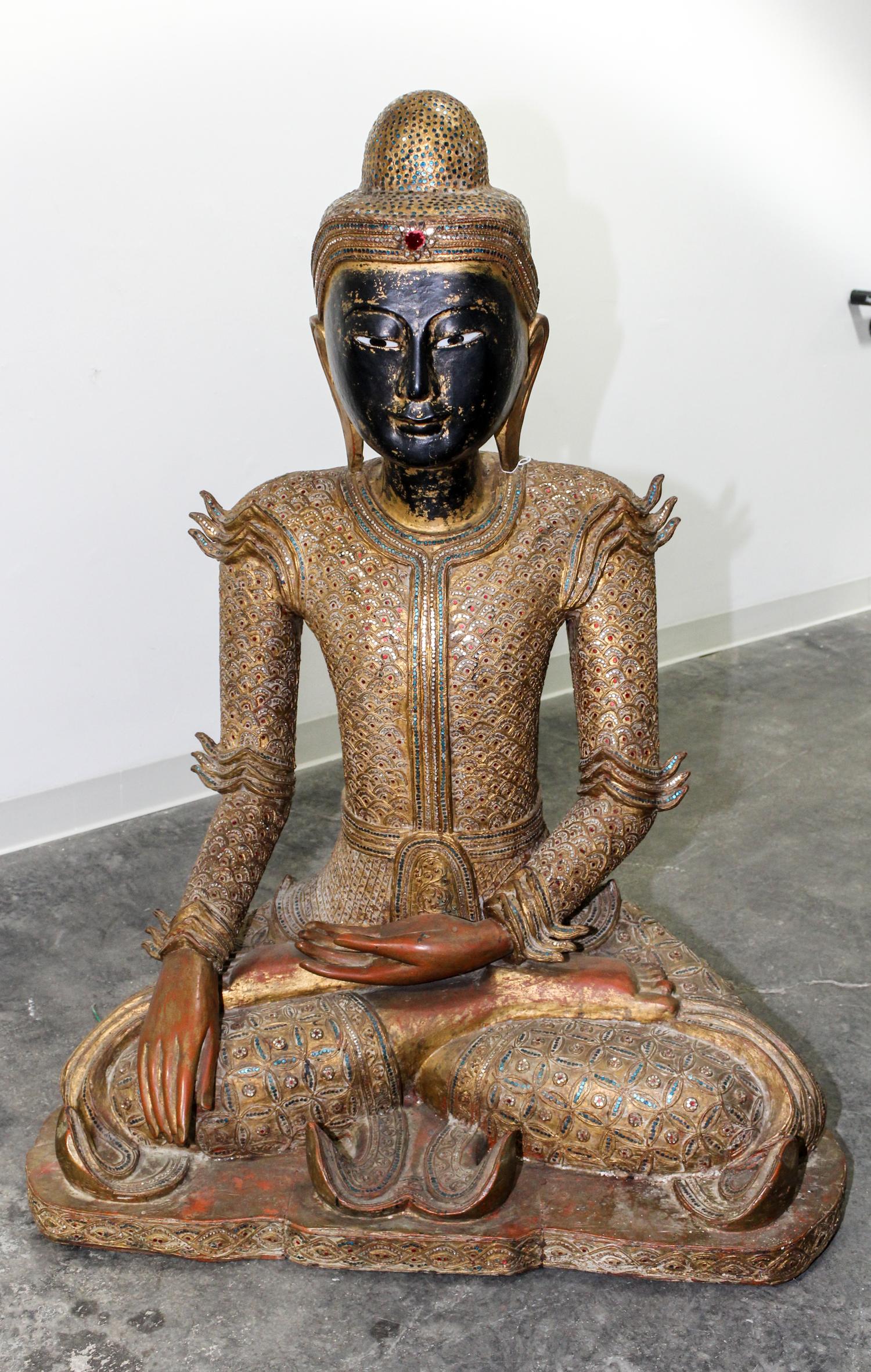 A Burmese Giltwood Seated Figure of Buddha Height 47 inches.